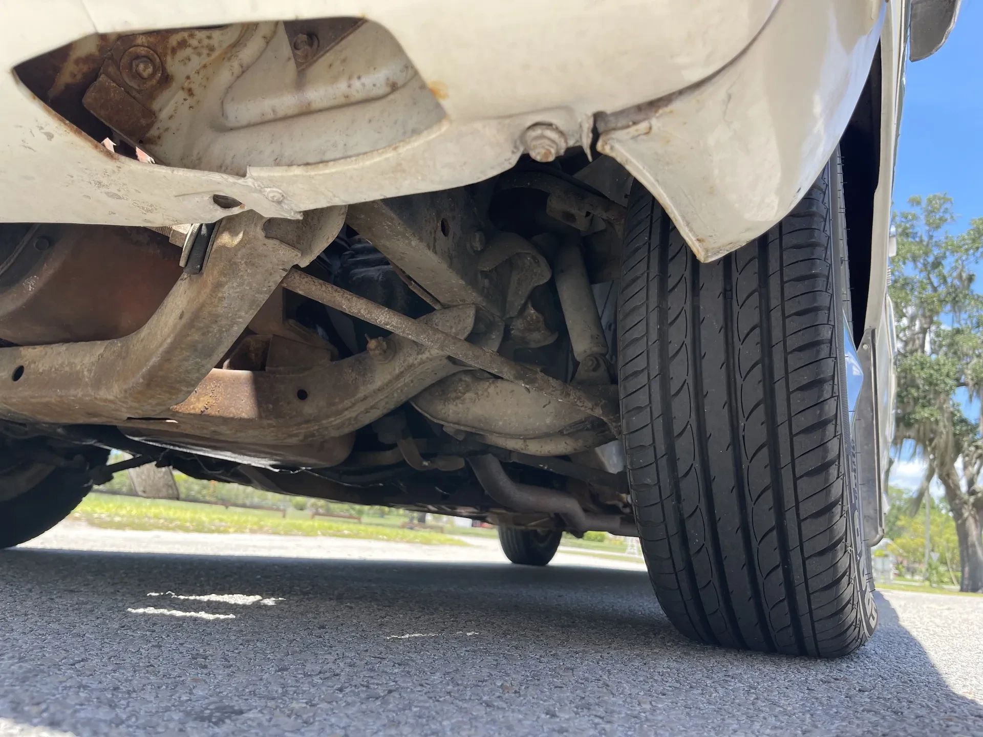1960–1962 Plymouth Valiant Versus 1986–1991 Ford Taurus – Closer Than They Appear 25 Close-up of the left front suspension of a 1961 Plymouth Valiant, photographed from the ground looking up and back