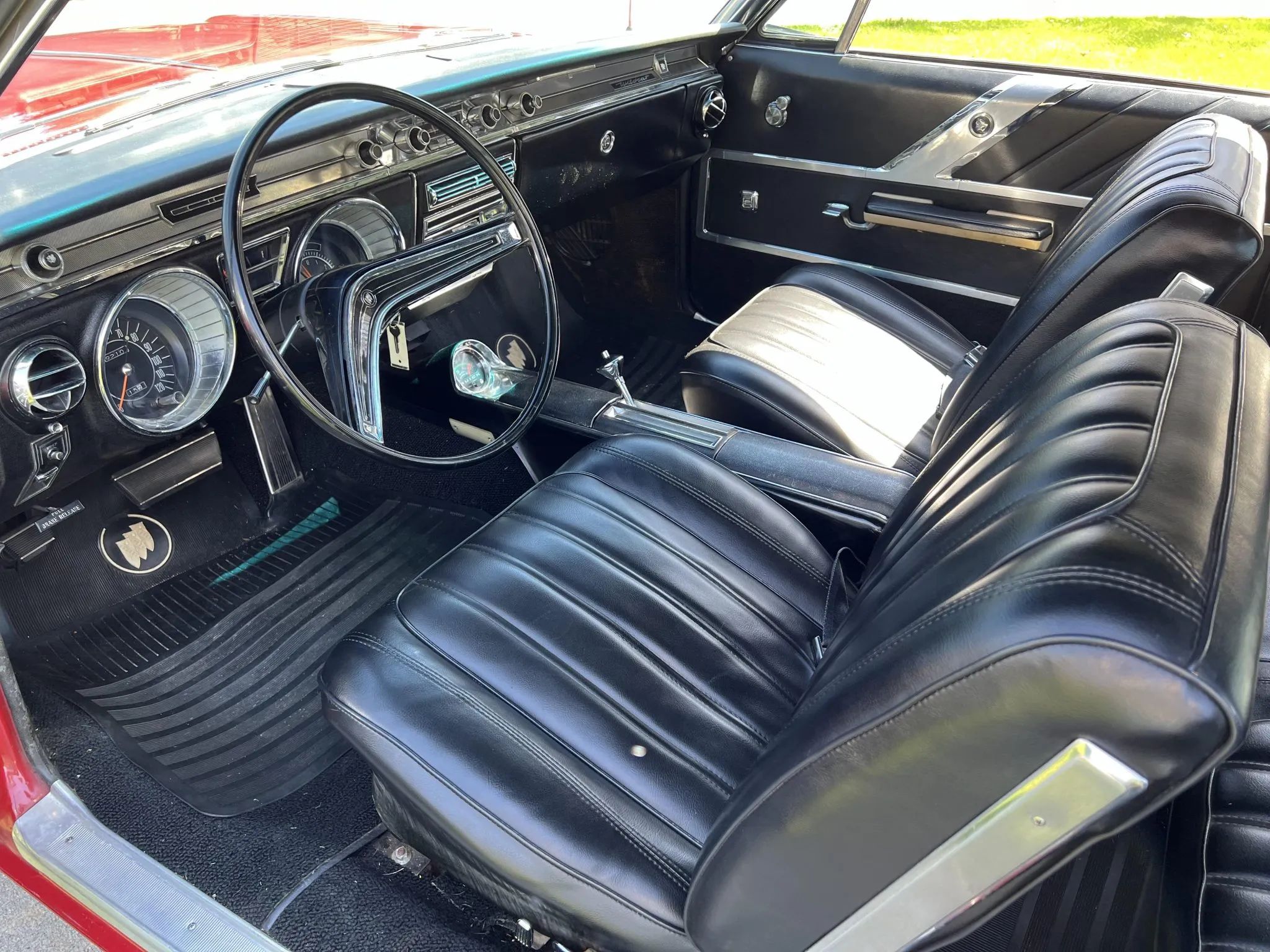 Full-Size Buicks Of The 1960s: How Buick Reinvented Its Lineup Between 1959 And 1970 23 Dashboard and front bucket seats of a 1965 Buick Wildcat Custom with black vinyl upholstery, viewed through the driver's door
