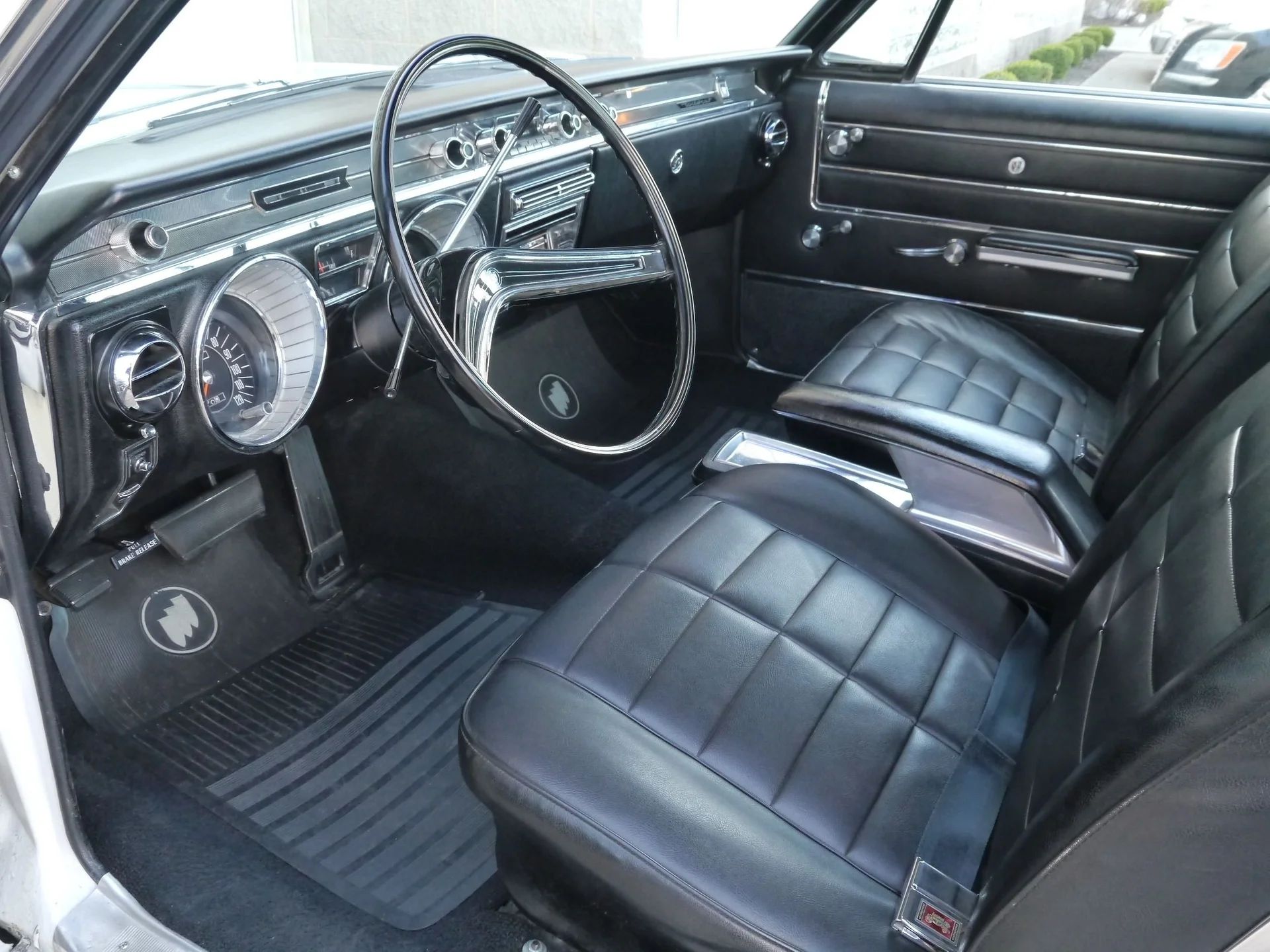 Full-Size Buicks Of The 1960s: How Buick Reinvented Its Lineup Between 1959 And 1970 22 Dashboard and front bucket seats of a 1965 Buick Wildcat Deluxe GS with black vinyl upholstery, viewed through the driver's door