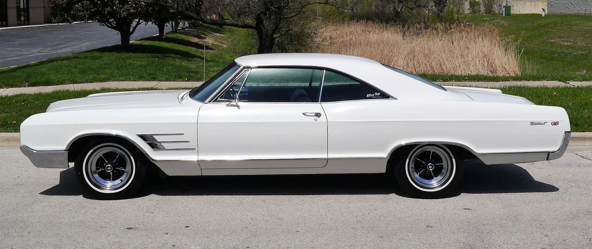 Full-Size Buicks Of The 1960s: How Buick Reinvented Its Lineup Between 1959 And 1970 18 Left side view of a white 1965 Buick Wildcat Deluxe two-door hardtop with chromed steel wheels and GS emblems