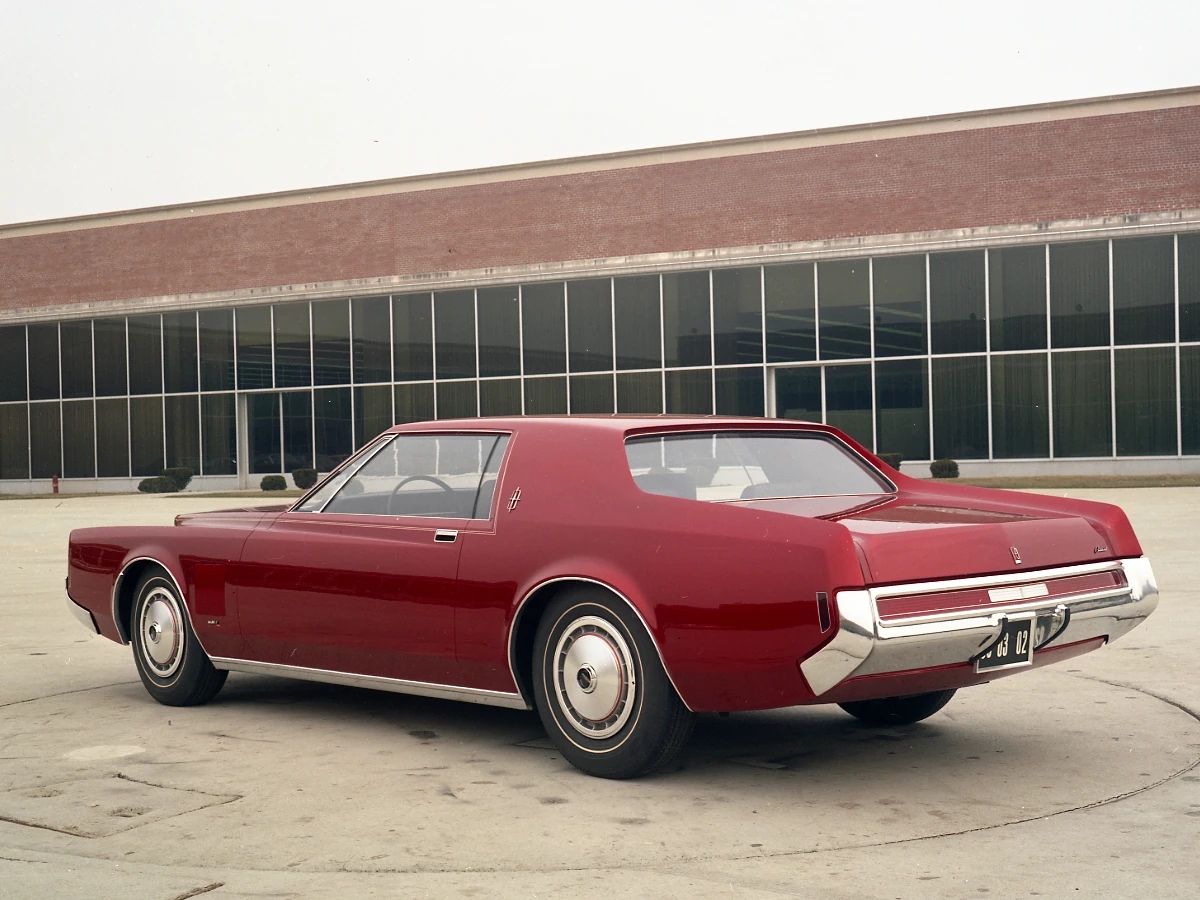 1977 Lincoln Continental Mark V: Bigger Than Ever, This Defiant Dinosaur Was Rolling In Green 7 Rear 3q of a dark red styling model of a Lincoln Continental Mark that looks like an enlarged Mustang hardtop with a lower roof