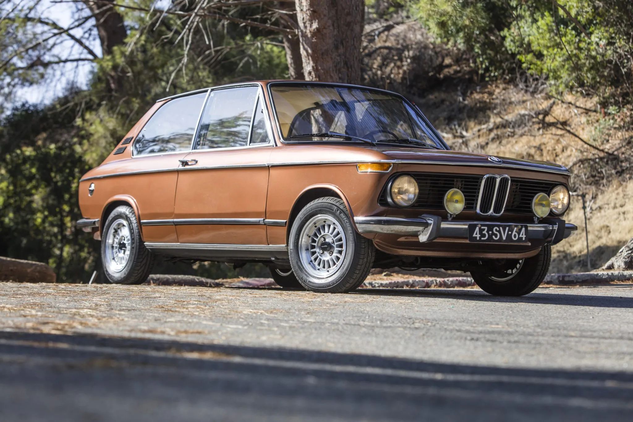 1972 BMW 2000 Touring – Rare BMW 2002 Hatchback Version, Never Sold In The U.S. 20 Low-angle front 3q view of a brown 1974 BMW 2002 Touring with alloy wheels and yellow driving lamps