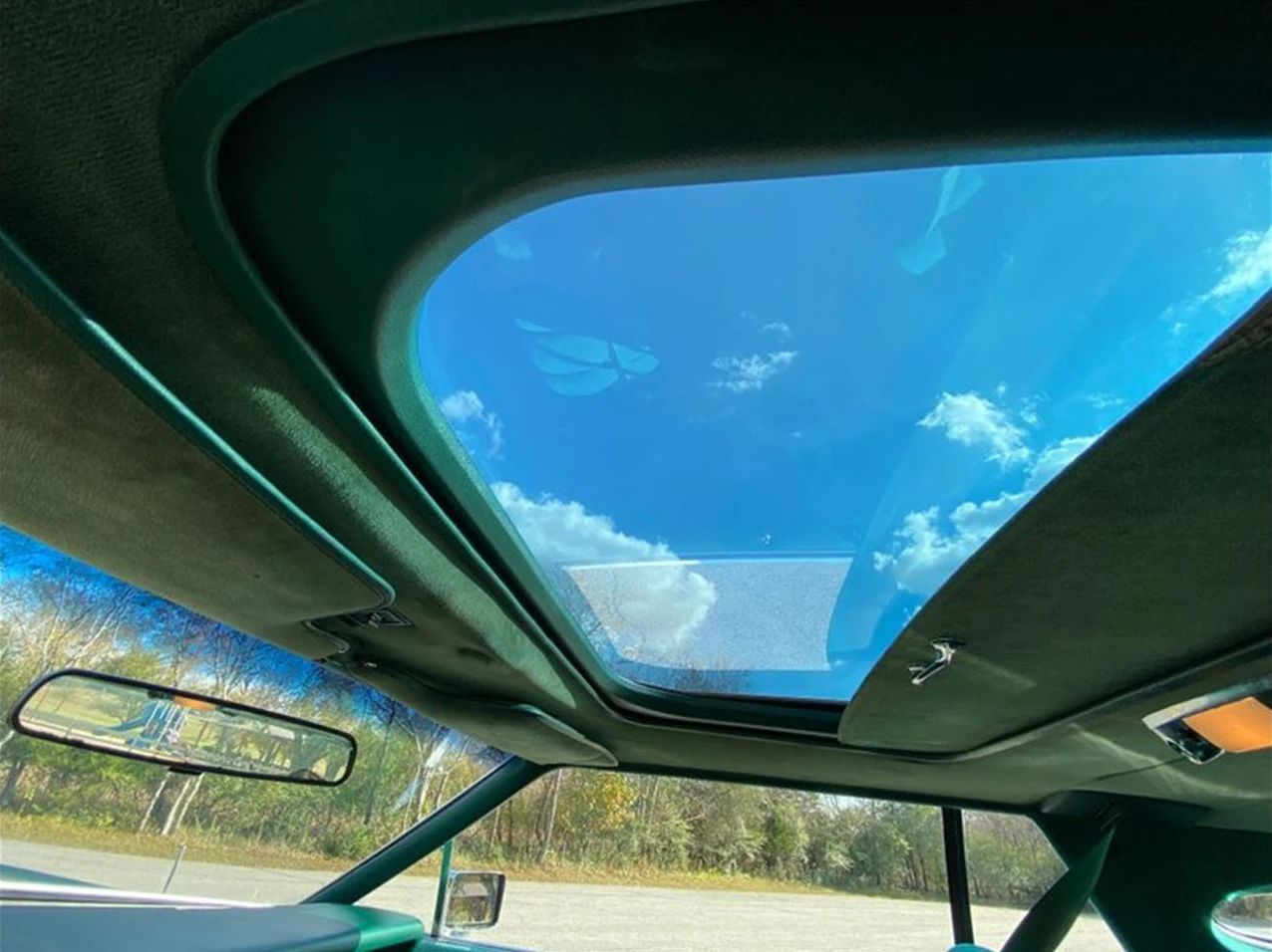 1977 Lincoln Continental Mark V: Bigger Than Ever, This Defiant Dinosaur Was Rolling In Green 20 Sunroof of a 1977 Lincoln Continental Mark V with a green interior, seen from the inside looking up