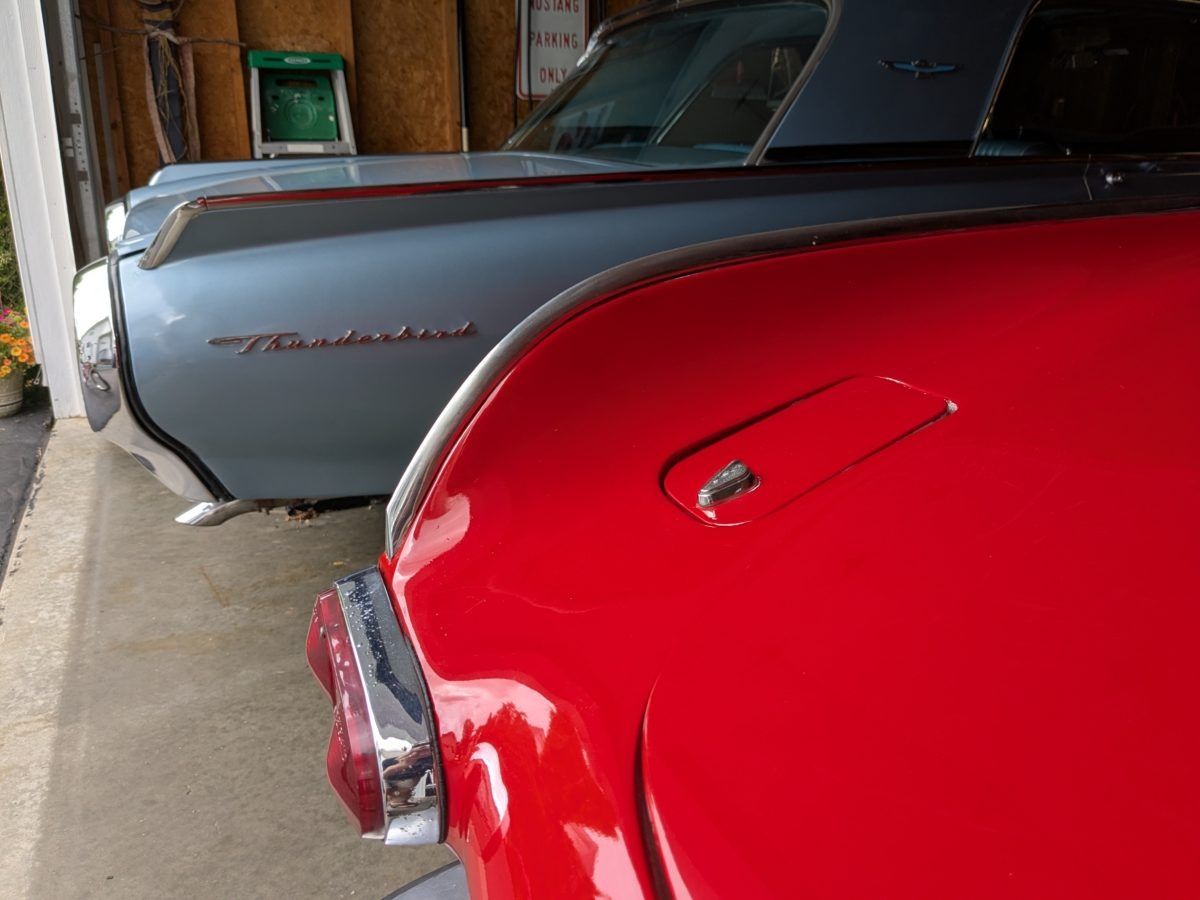 Fin of the 1967 Volvo 1800S, with the tail of a blue Thunderbird in the background