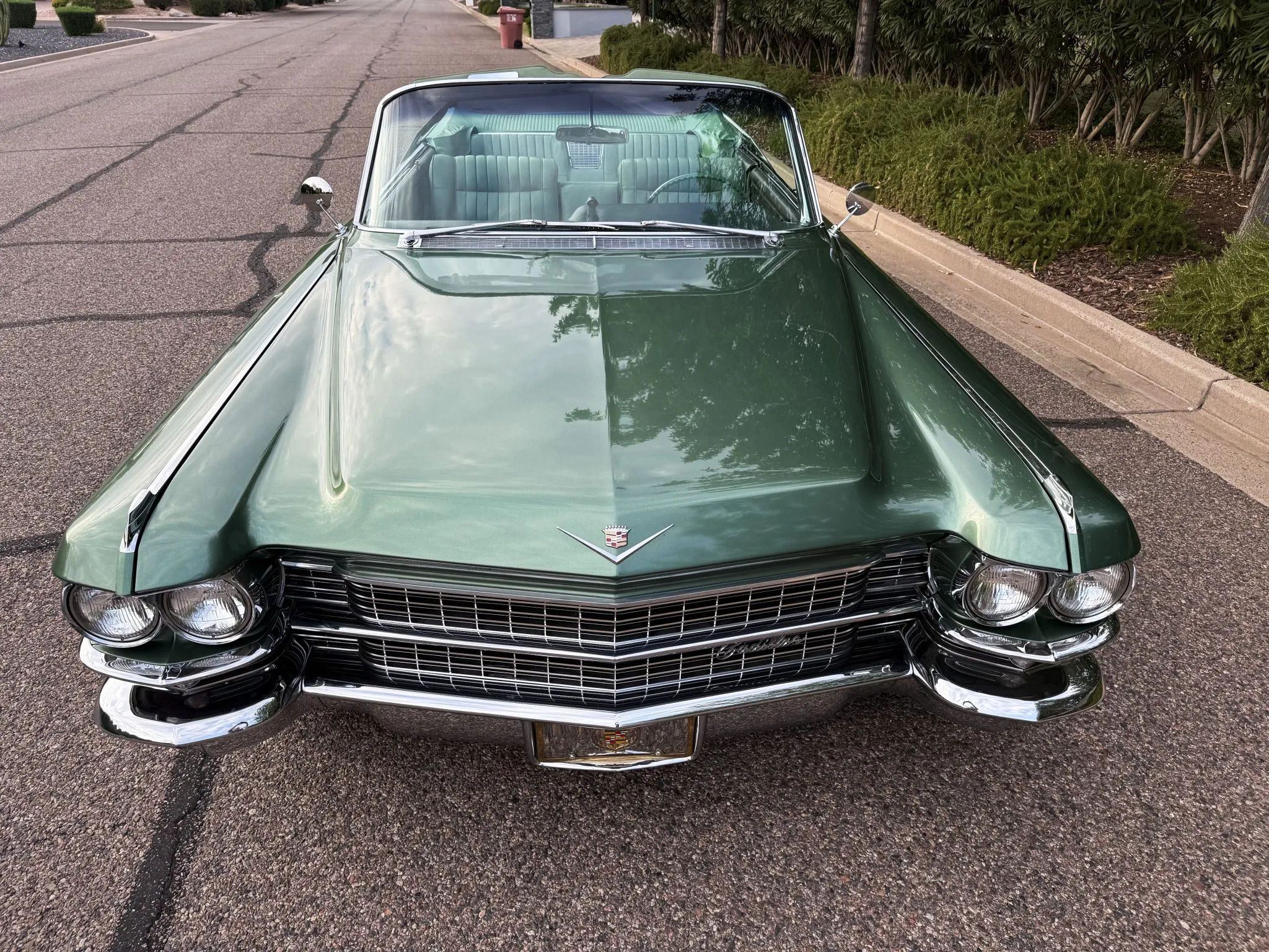Color-Coordinated Cadillacs: Colorful Eldorados, De Villes, And Fleetwood Broughams 38 High-angle front view of a green 1963 Cadillac Eldorado convertible with the top down