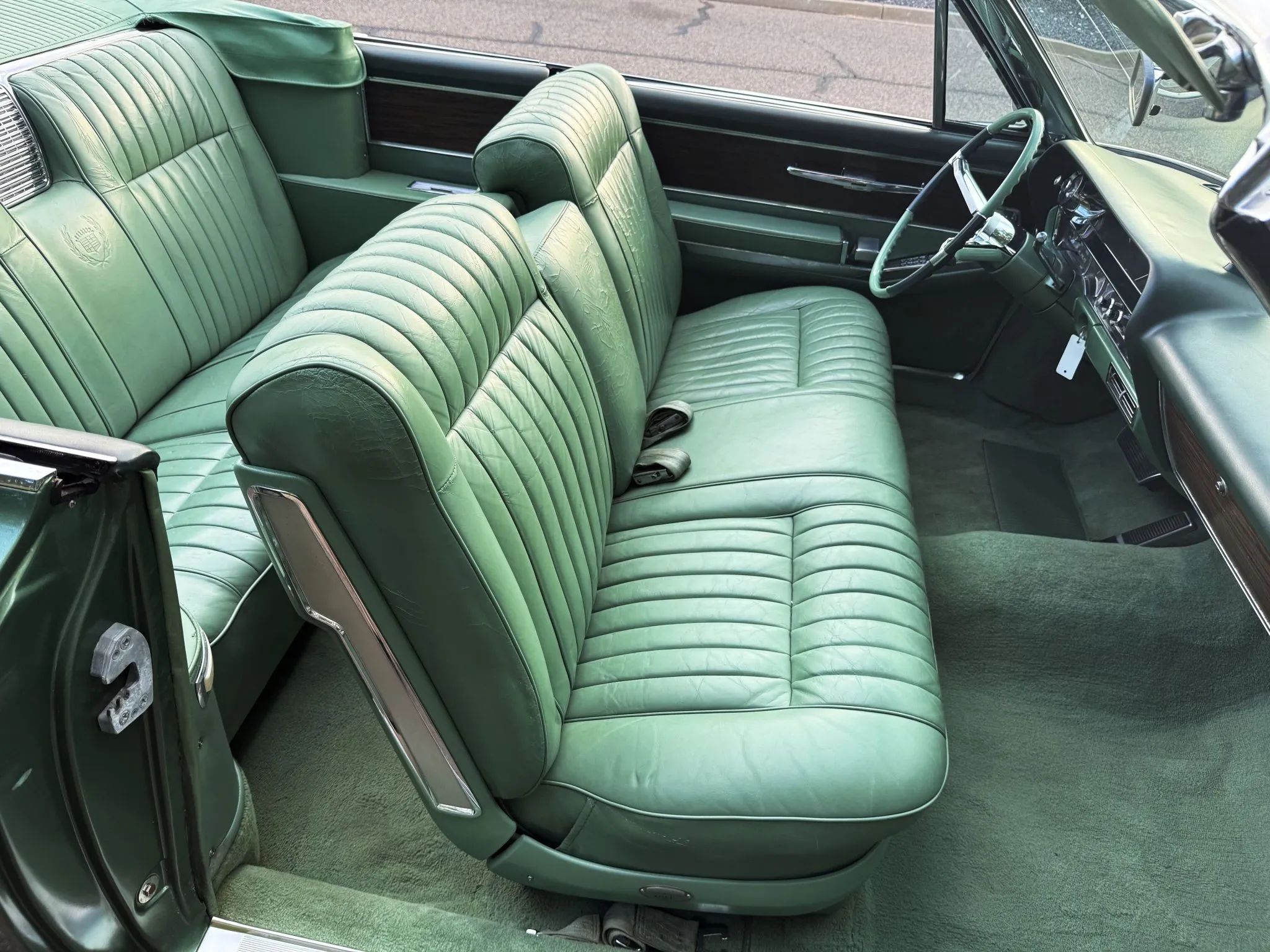 Color-Coordinated Cadillacs: Colorful Eldorados, De Villes, And Fleetwood Broughams 39 Green leather front seat of a 1963 Cadillac Eldorado convertible with the top down