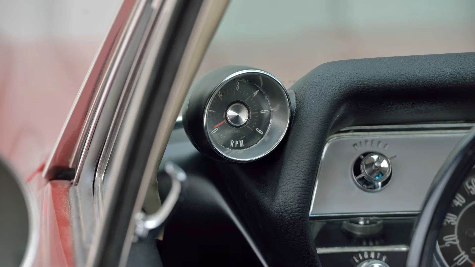 Tachometer on the left side of the dash of a 1966 Oldsmobile 4-4-2