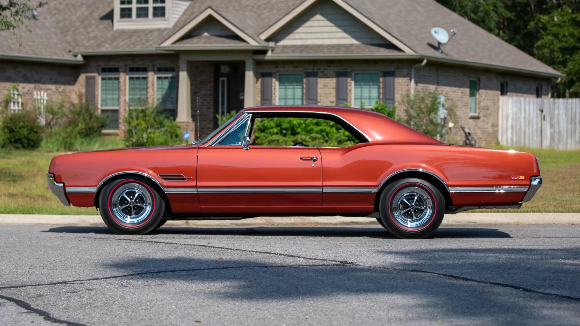 Left side view of a bronze 1966 Oldsmobile 4-4-2 hardtop