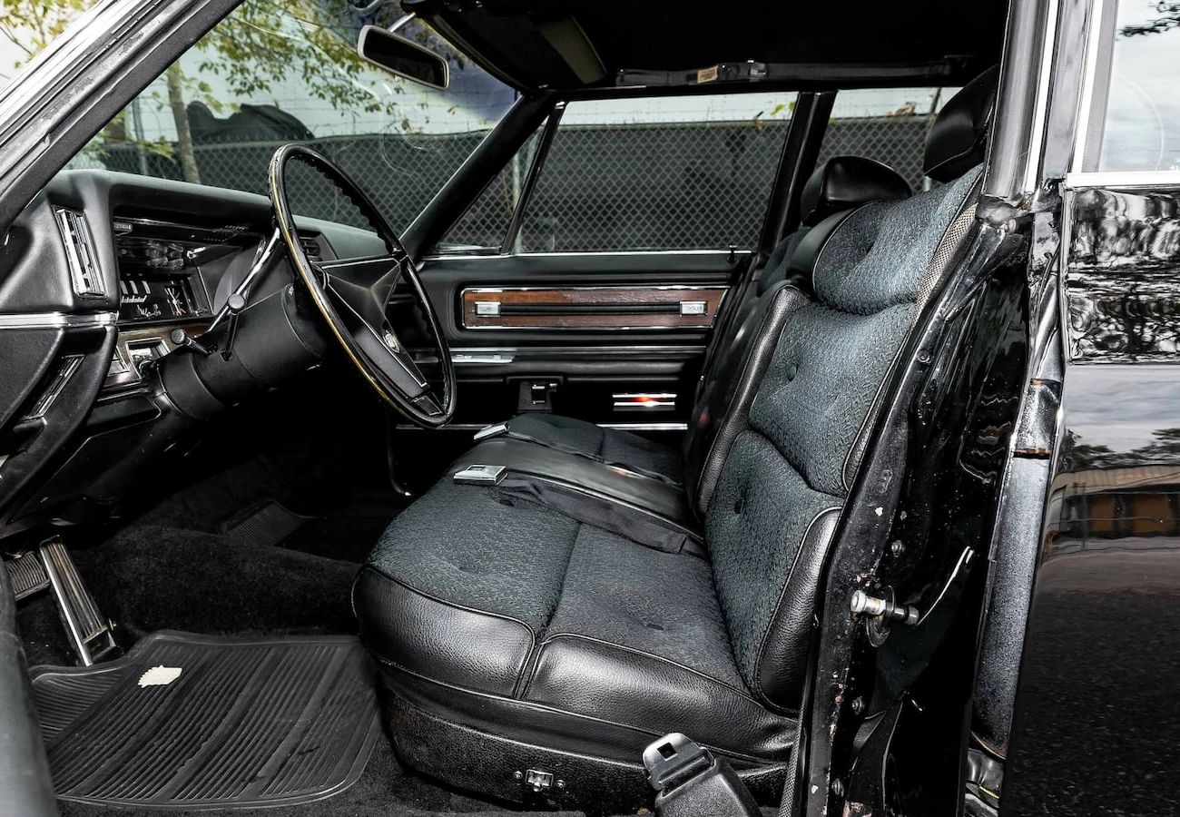 Color-Coordinated Cadillacs: Colorful Eldorados, De Villes, And Fleetwood Broughams 5 Front seat of a black 1968 Cadillac Fleetwood Brougham with black cloth upholstery