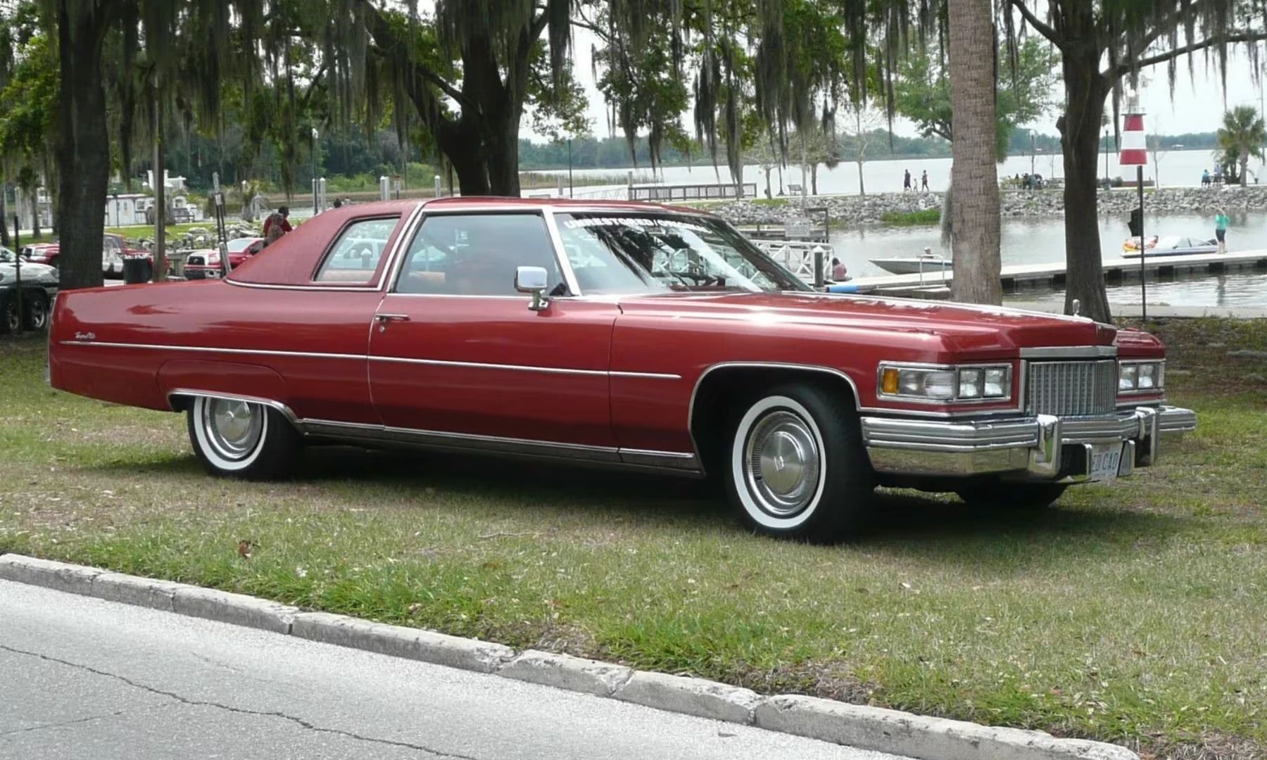 Color-Coordinated Cadillacs: Colorful Eldorados, De Villes, And Fleetwood Broughams 7 Front 3q view of a red 1975 Cadillac Coupe de Ville with a matching vinyl top