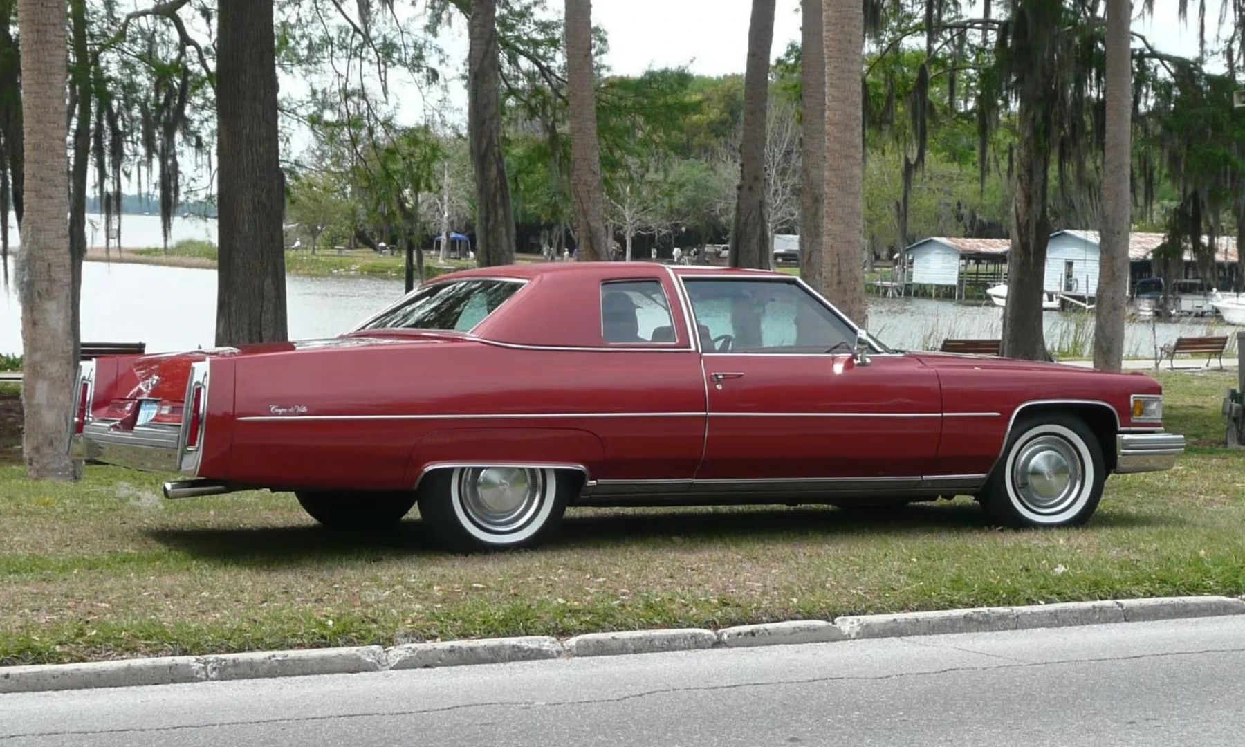 Color-Coordinated Cadillacs: Colorful Eldorados, De Villes, And Fleetwood Broughams 8 Right rear 3q view of a red 1975 Cadillac Coupe de Ville with a matching vinyl top