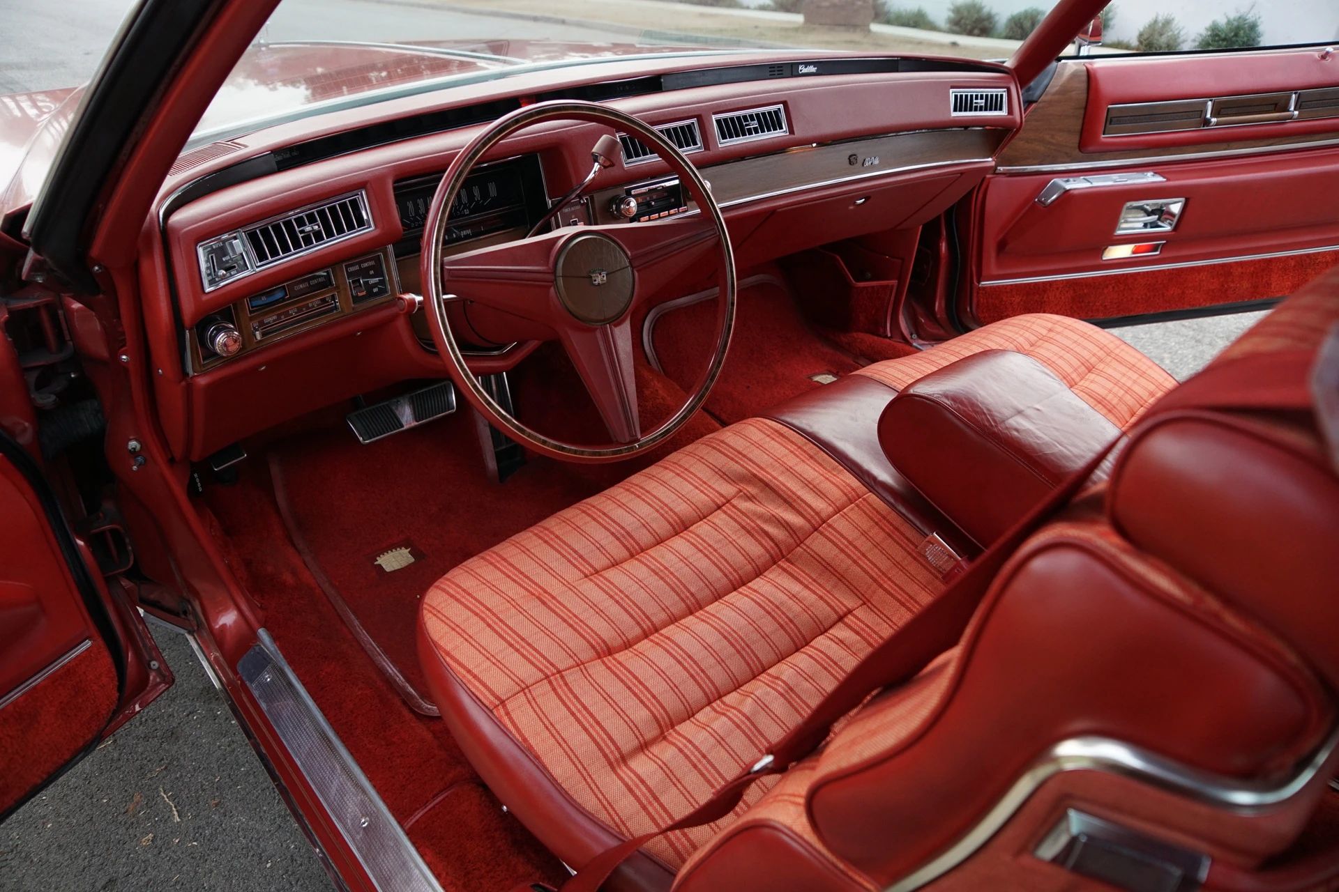 Color-Coordinated Cadillacs: Colorful Eldorados, De Villes, And Fleetwood Broughams 9 Dashboard and front seat of a 1975 Cadillac Coupe de Ville with a red interior and paid seat inserts