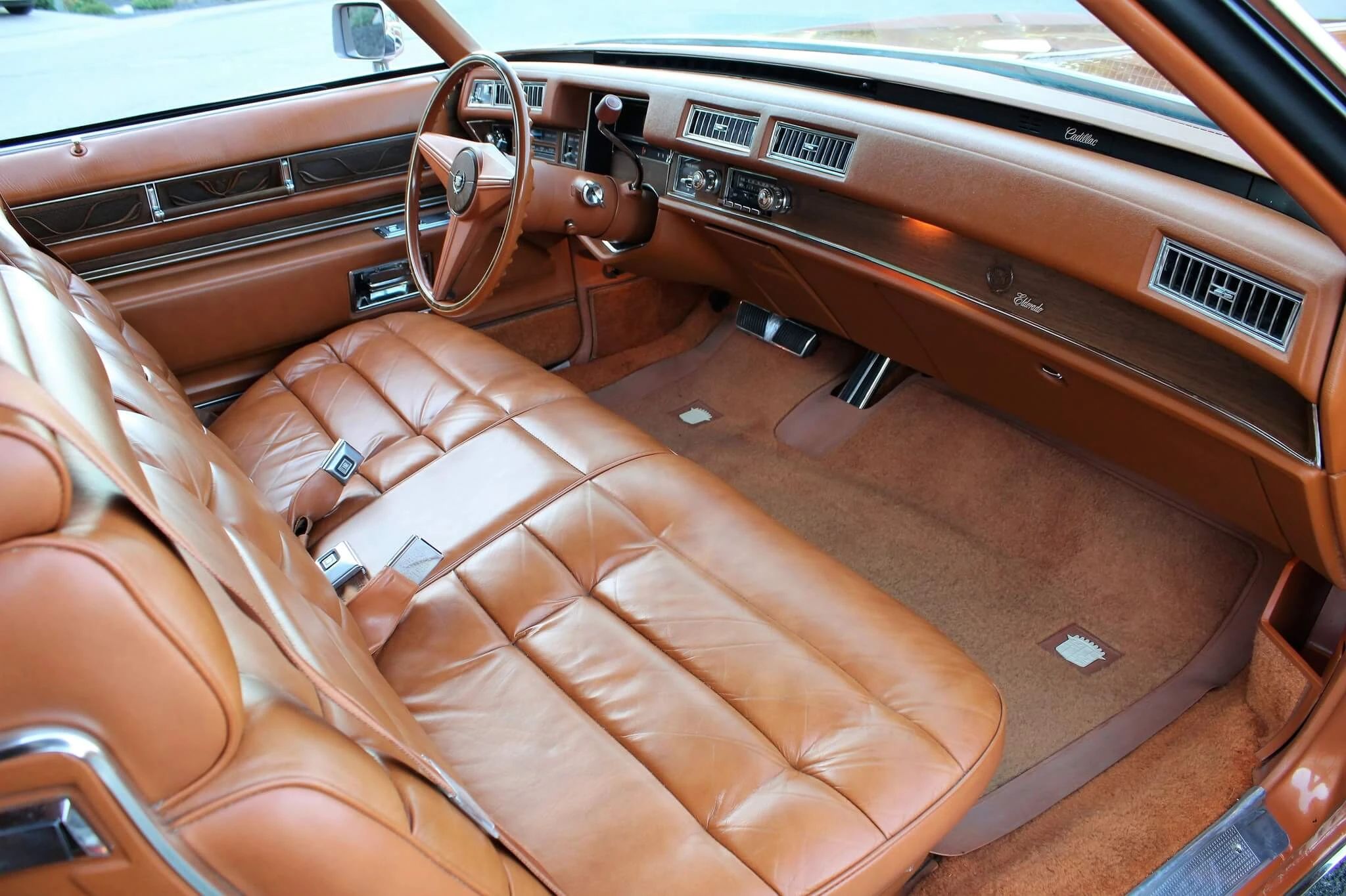 Color-Coordinated Cadillacs: Colorful Eldorados, De Villes, And Fleetwood Broughams 12 Right side of the dashboard and front seat of a 1975 Cadillac Eldorado with orange leather upholstery