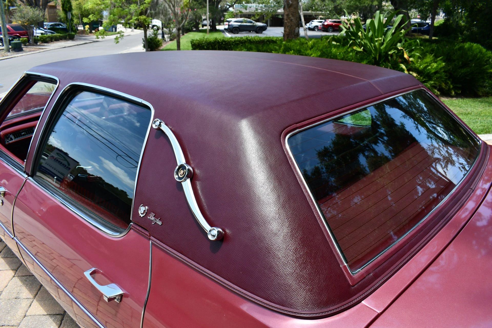 Color-Coordinated Cadillacs: Colorful Eldorados, De Villes, And Fleetwood Broughams 33 Padded vinyl top and landau iron on a cerise 1975 Cadillac Fleetwood Brougham