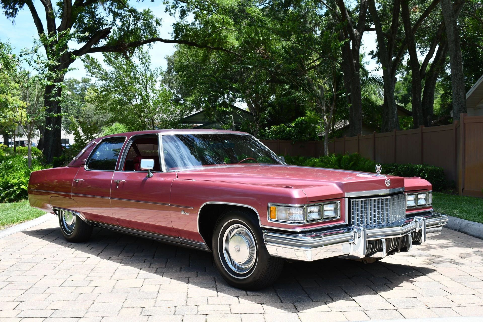 Color-Coordinated Cadillacs: Colorful Eldorados, De Villes, And Fleetwood Broughams 30 Right front view of a cerise 1975 Cadillac Fleetwood Brougham with a matching vinyl top