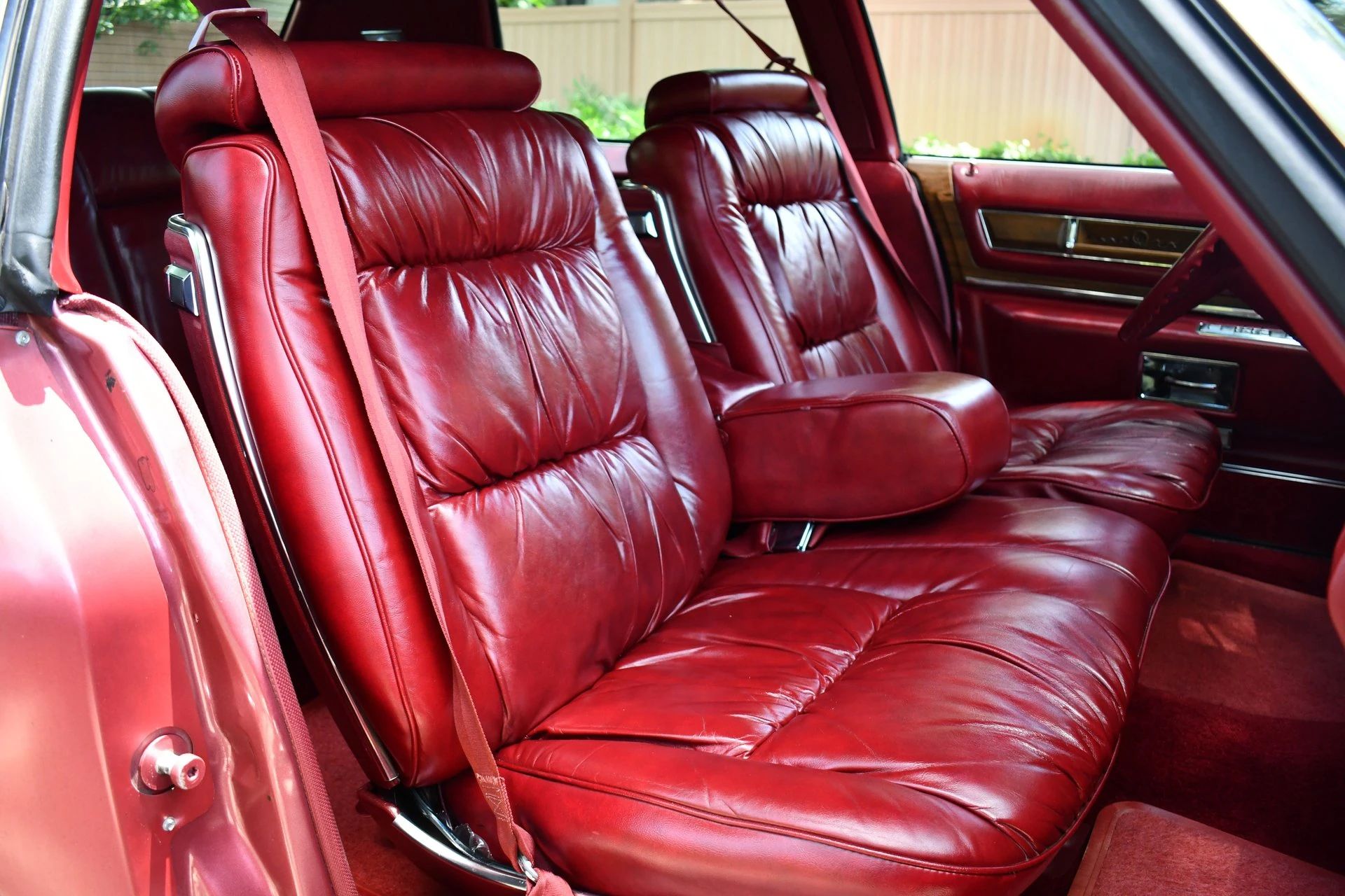 Color-Coordinated Cadillacs: Colorful Eldorados, De Villes, And Fleetwood Broughams 32 Leather front seat of a cerise 1975 Cadillac Fleetwood Brougham