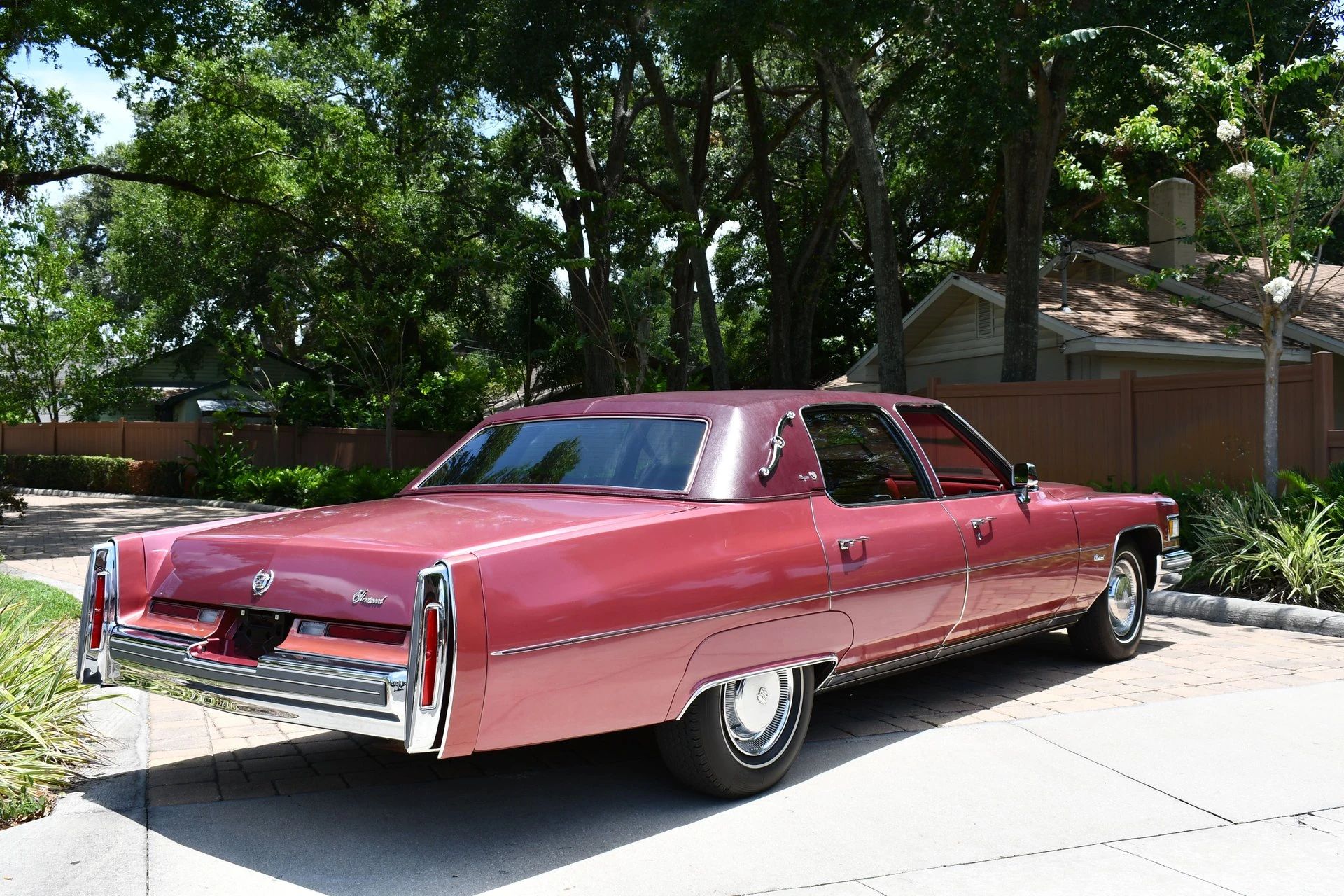Color-Coordinated Cadillacs: Colorful Eldorados, De Villes, And Fleetwood Broughams 31 Right rear 3q view of a cerise 1975 Cadillac Fleetwood Brougham with a matching vinyl top and landau irons