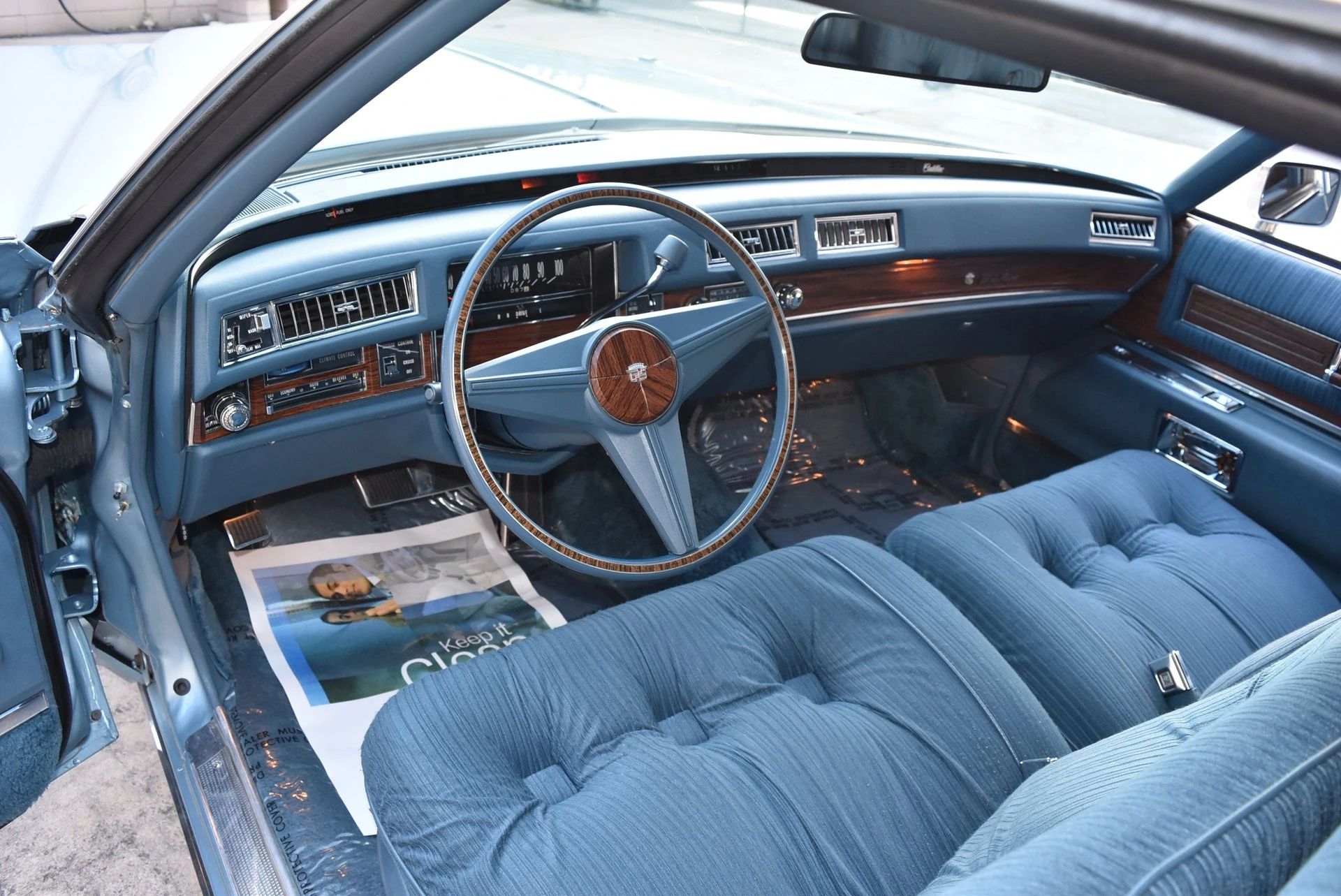 Color-Coordinated Cadillacs: Colorful Eldorados, De Villes, And Fleetwood Broughams 22 Dashboard of a 1976 Cadillac Coupe de Ville with a blue interior and cloth upholstery
