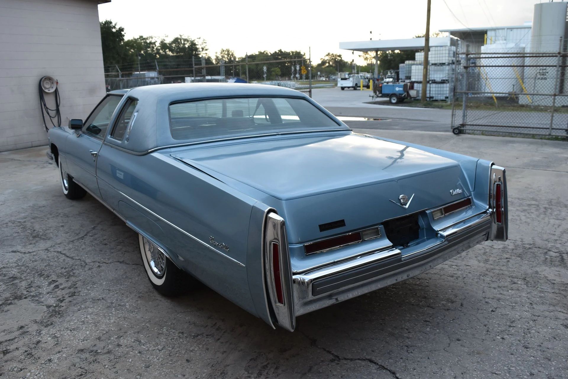 Color-Coordinated Cadillacs: Colorful Eldorados, De Villes, And Fleetwood Broughams 21 Left rear view of a blue 1976 Cadillac Coupe de Ville with a matching vinyl top