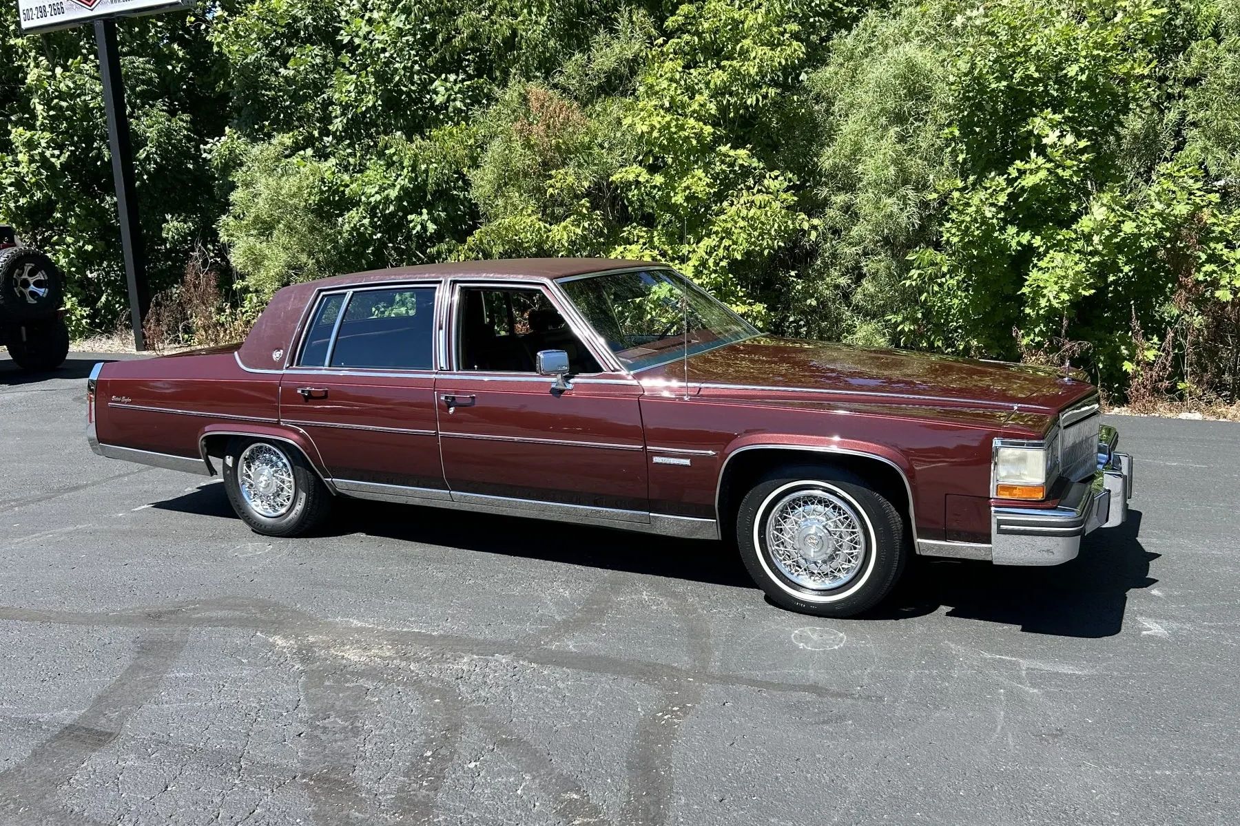 Color-Coordinated Cadillacs: Colorful Eldorados, De Villes, And Fleetwood Broughams 27 Right side view of a maroon 1983 Cadillac Fleetwood Brougham with a matching vinyl top