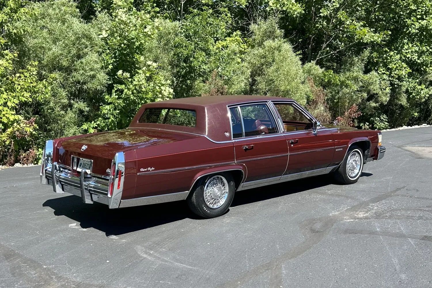 Color-Coordinated Cadillacs: Colorful Eldorados, De Villes, And Fleetwood Broughams 28 Right rear 3q view of a maroon 1983 Cadillac Fleetwood Brougham with a matching vinyl top