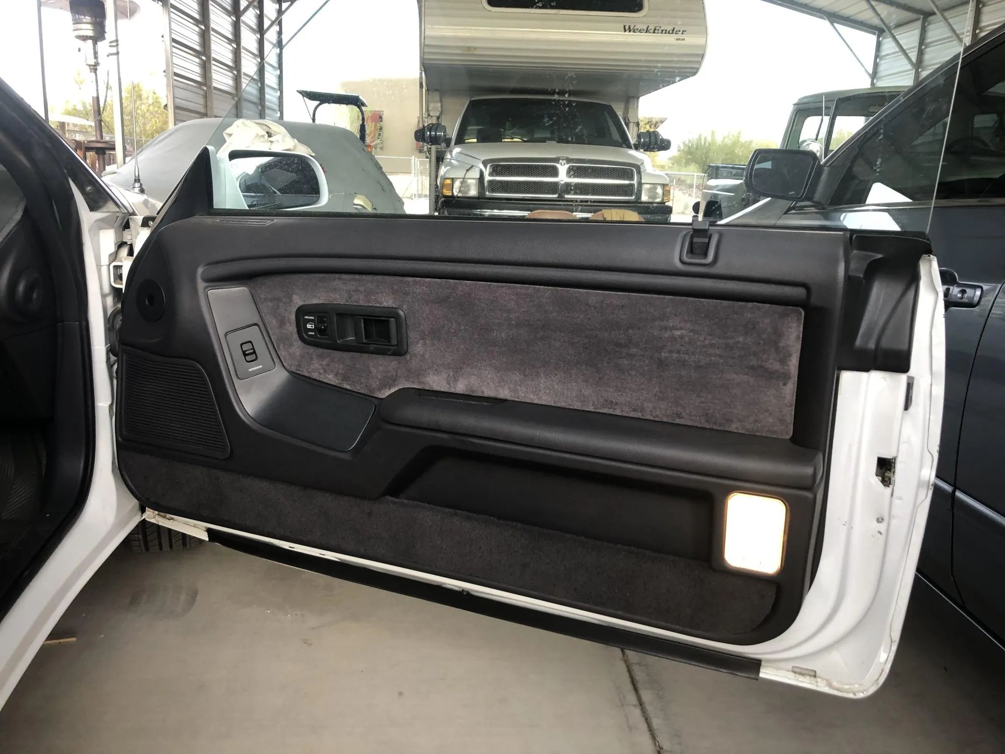 1994–1995 Chrysler LeBaron GTC Convertible – A Rental Car Favorite Nears Its Final Curtain 12 Passenger door trim of a white 1995 Chrysler LeBaron with gray cloth upholstery