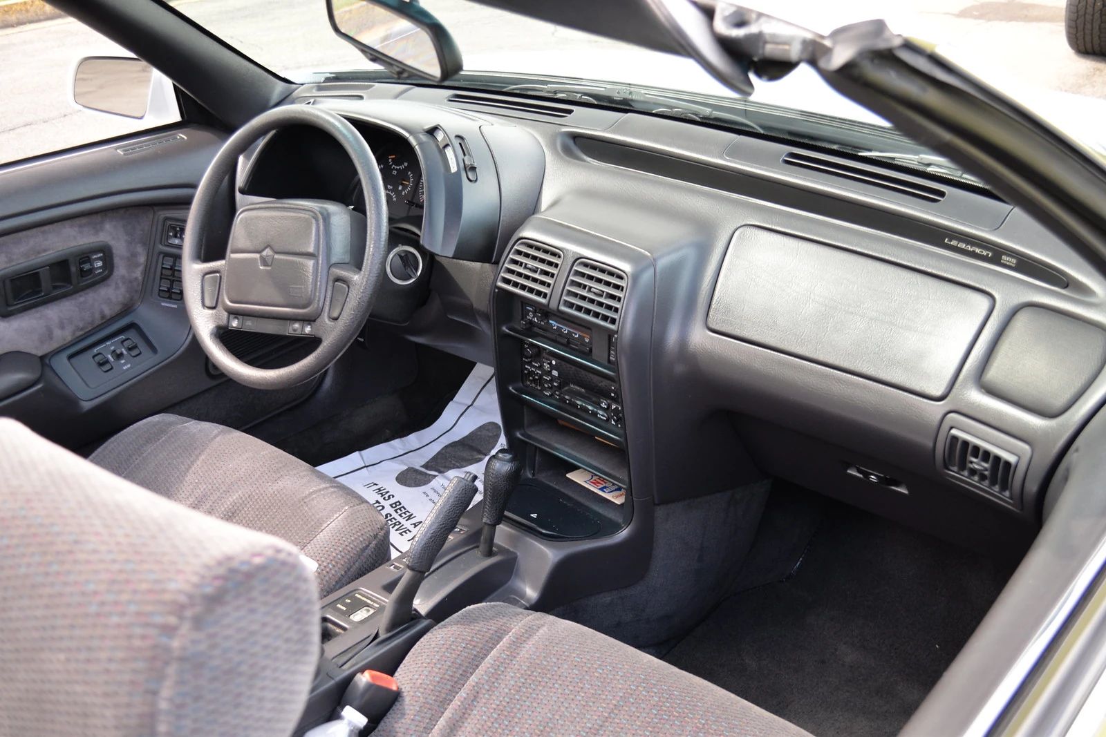 1994–1995 Chrysler LeBaron GTC Convertible – A Rental Car Favorite Nears Its Final Curtain 14 Dashboard and front seats of a 1994 or 1995 Chrysler LeBaron convertible with gray cloth seats