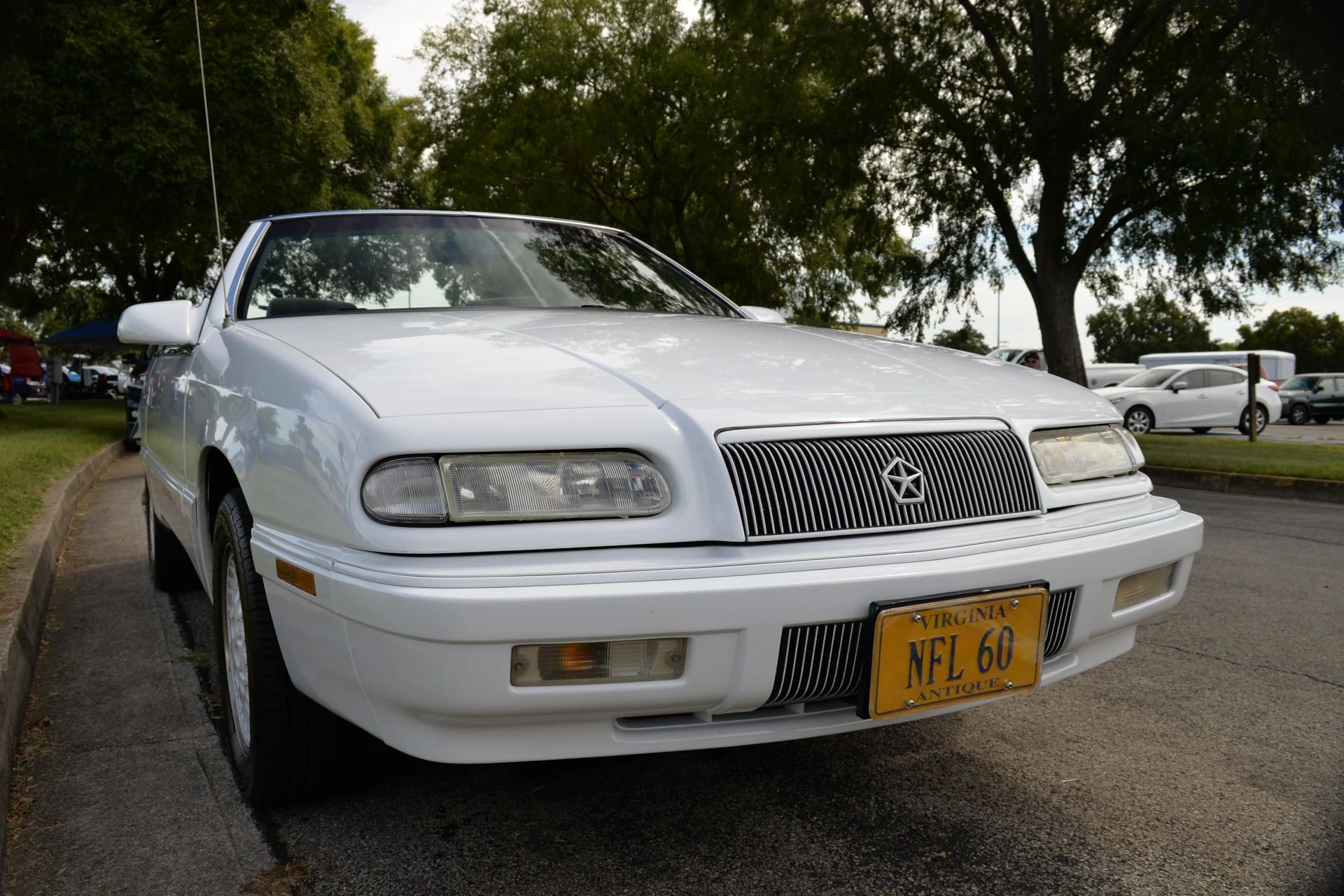 1994–1995 Chrysler LeBaron GTC Convertible – A Rental Car Favorite Nears Its Final Curtain 3 Front view of a white 1994 or 1995 Chrysler LeBaron with Virginia antique license plate reading NFL 60