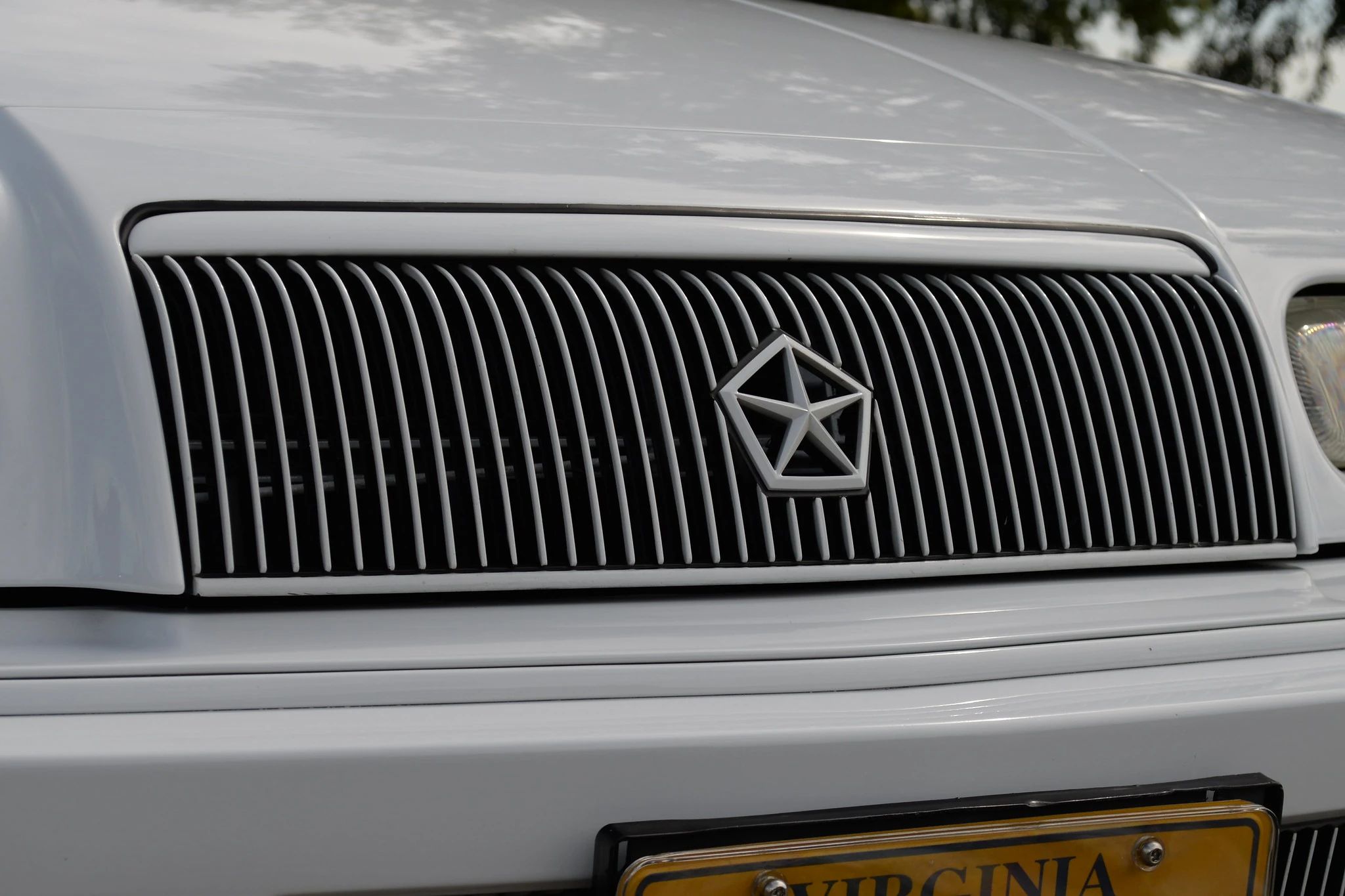 1994–1995 Chrysler LeBaron GTC Convertible – A Rental Car Favorite Nears Its Final Curtain 16 Close-up of the grille of a white 1994 or 1995 Chrysler LeBaron