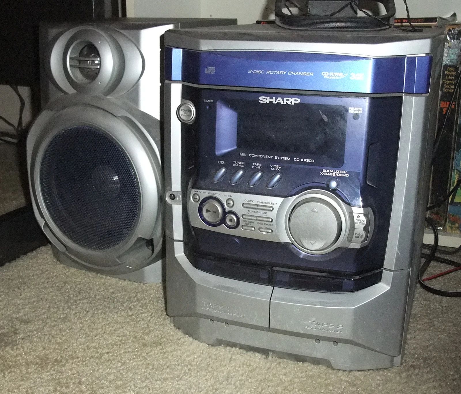 1994–1995 Chrysler LeBaron GTC Convertible – A Rental Car Favorite Nears Its Final Curtain 2 Photo of a dusty silver and blue Sharp all-in-one stereo with a three-disc CD changer, sitting next to one of its speakers