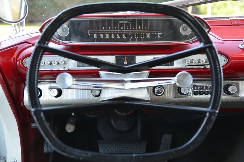 From Chrome To Clear Plastic: Bold Steering Wheels Of The 1950s & 1960s 27 Dashboard and black steering wheel of a 1960 Plymouth Fury sedan with a red dashboard