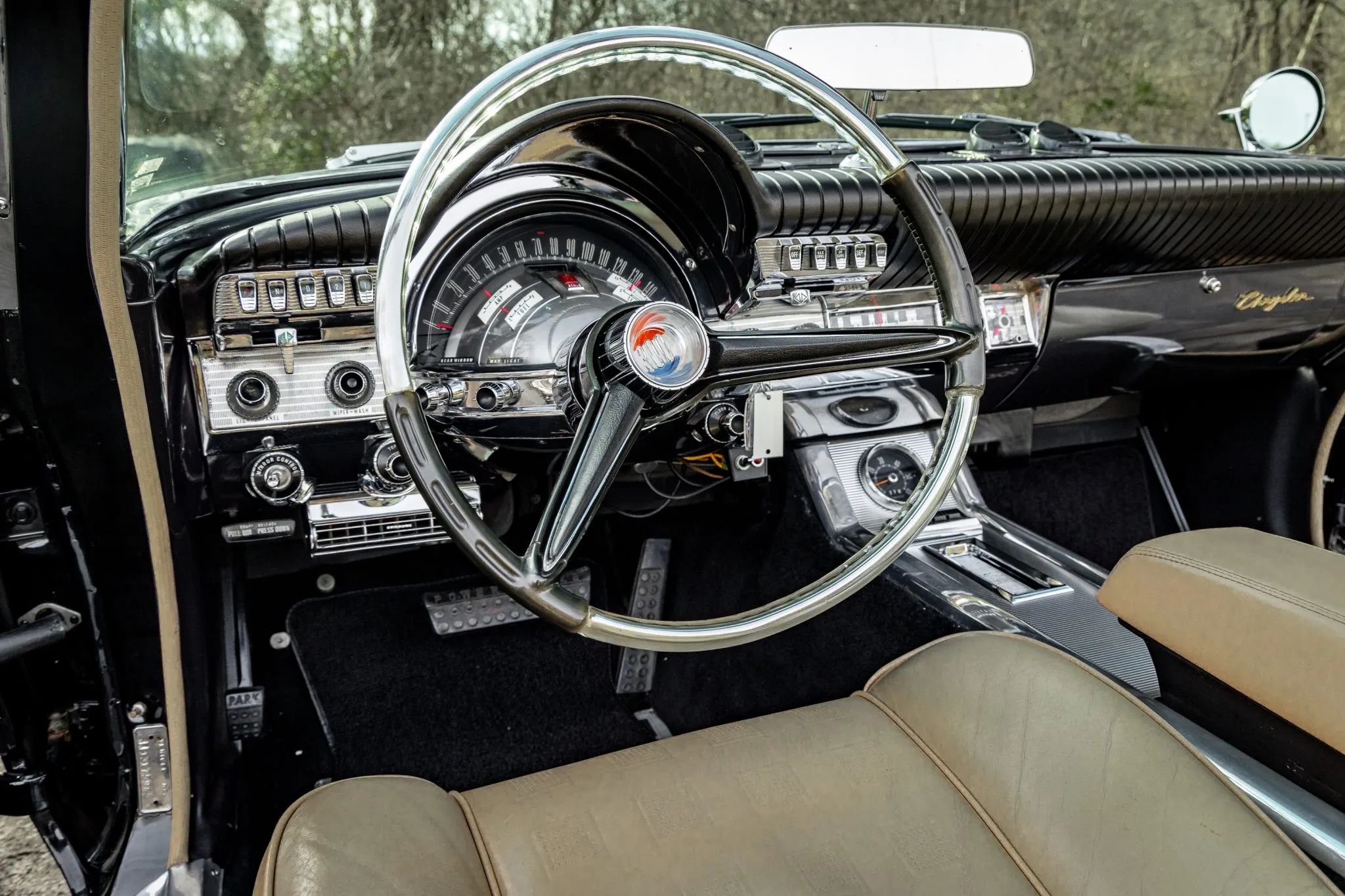 From Chrome To Clear Plastic: Bold Steering Wheels Of The 1950s & 1960s 33 Dashboard and transparent steering wheel of a 1961 Chrysler 300G convertible with a black dashboard and tan leather seats