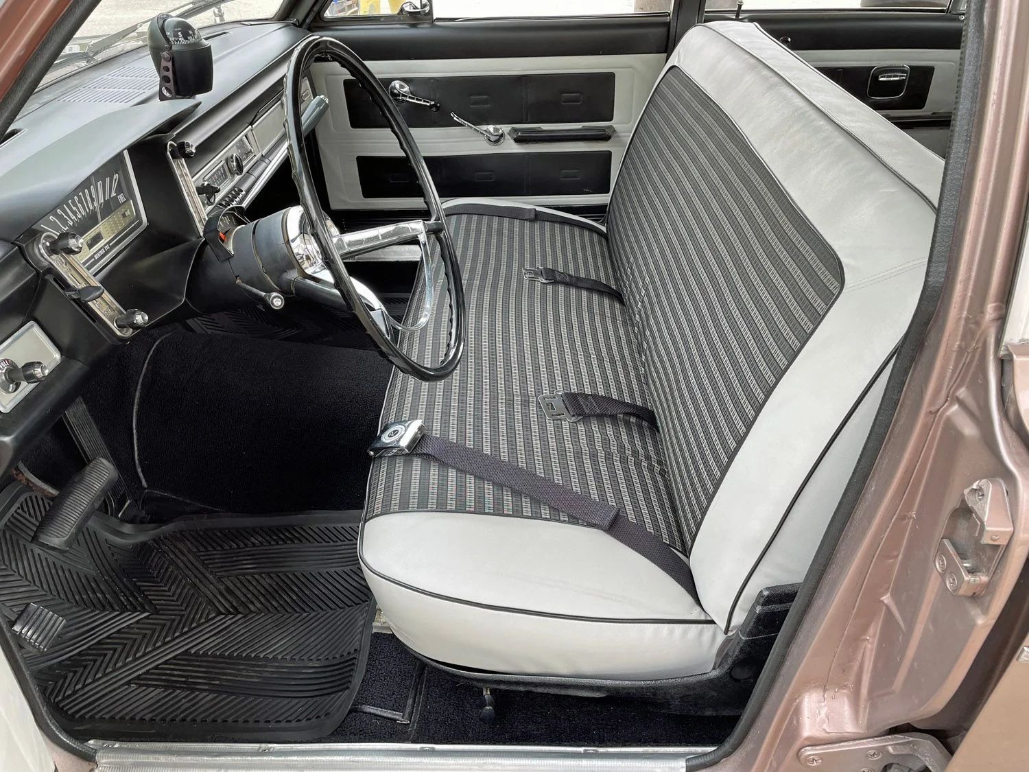 Front bench seat of a 1963 Rambler Classic sedan with black-and-white vinyl and cloth upholstery
