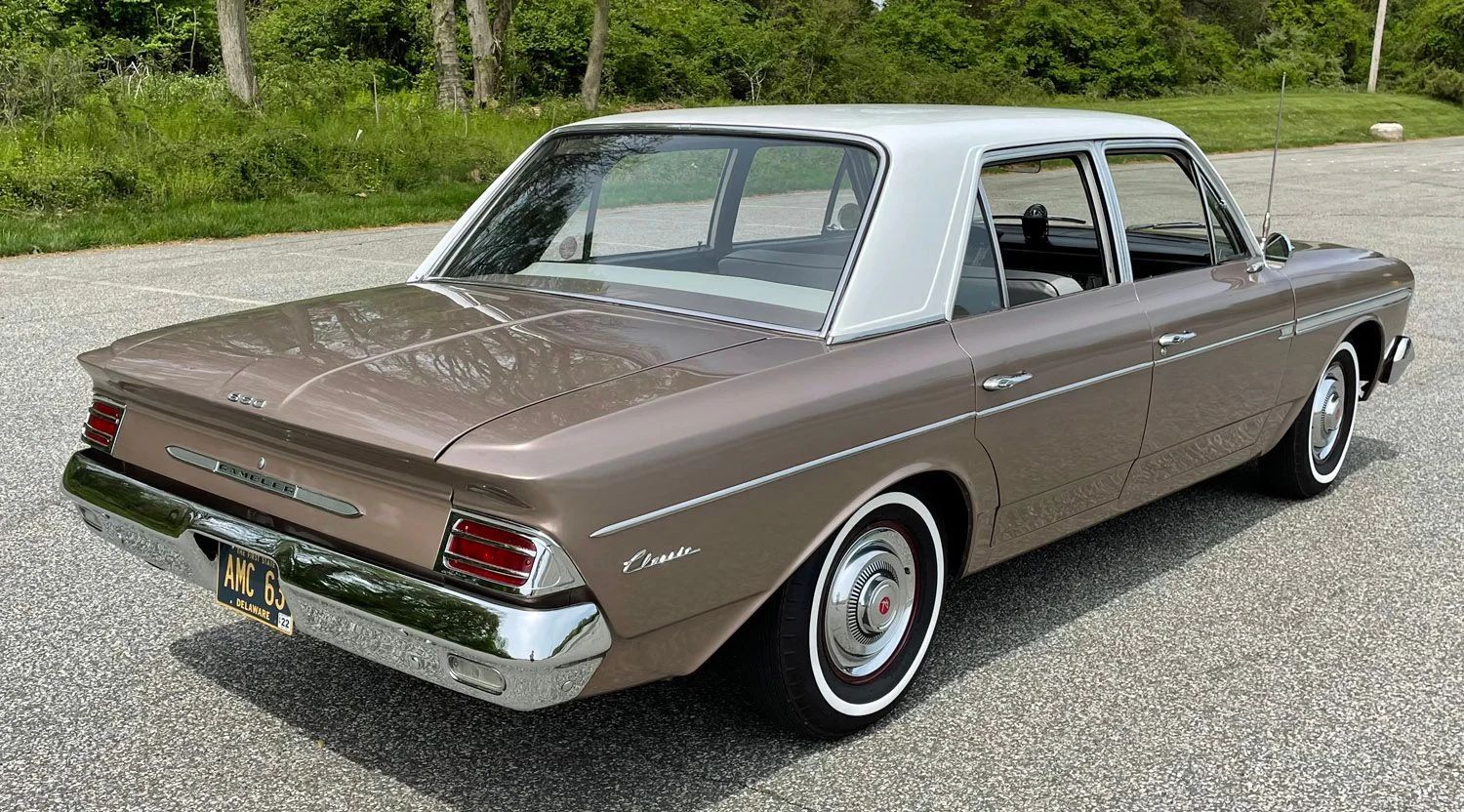 Right rear 3q view of a coral 1963 Rambler Classic four-door sedan with a white roof