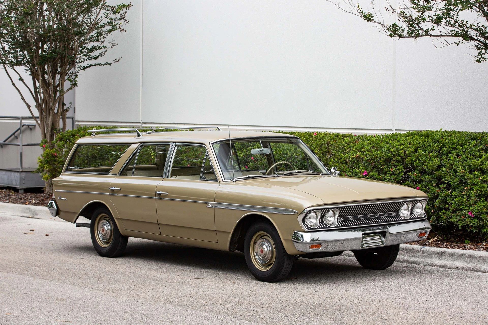 Right front 3q view of a gold 1963 Rambler Classic four-door station wagon with dog dish hubcaps