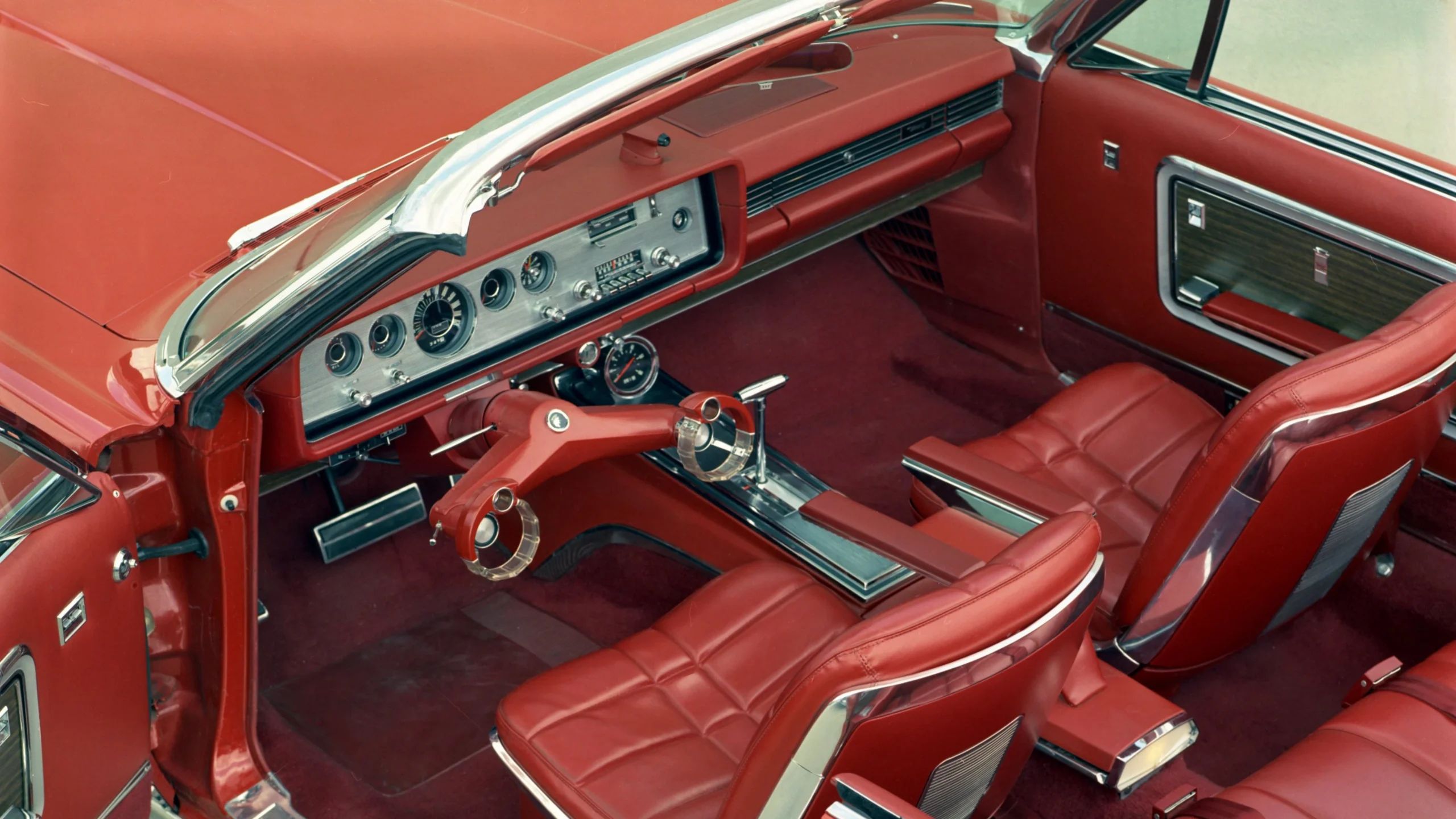 From Chrome To Clear Plastic: Bold Steering Wheels Of The 1950s & 1960s 4 Vintage color press photo of an orange 1965 Mercury Park Lane convertible with Wrist Twist steering yoke