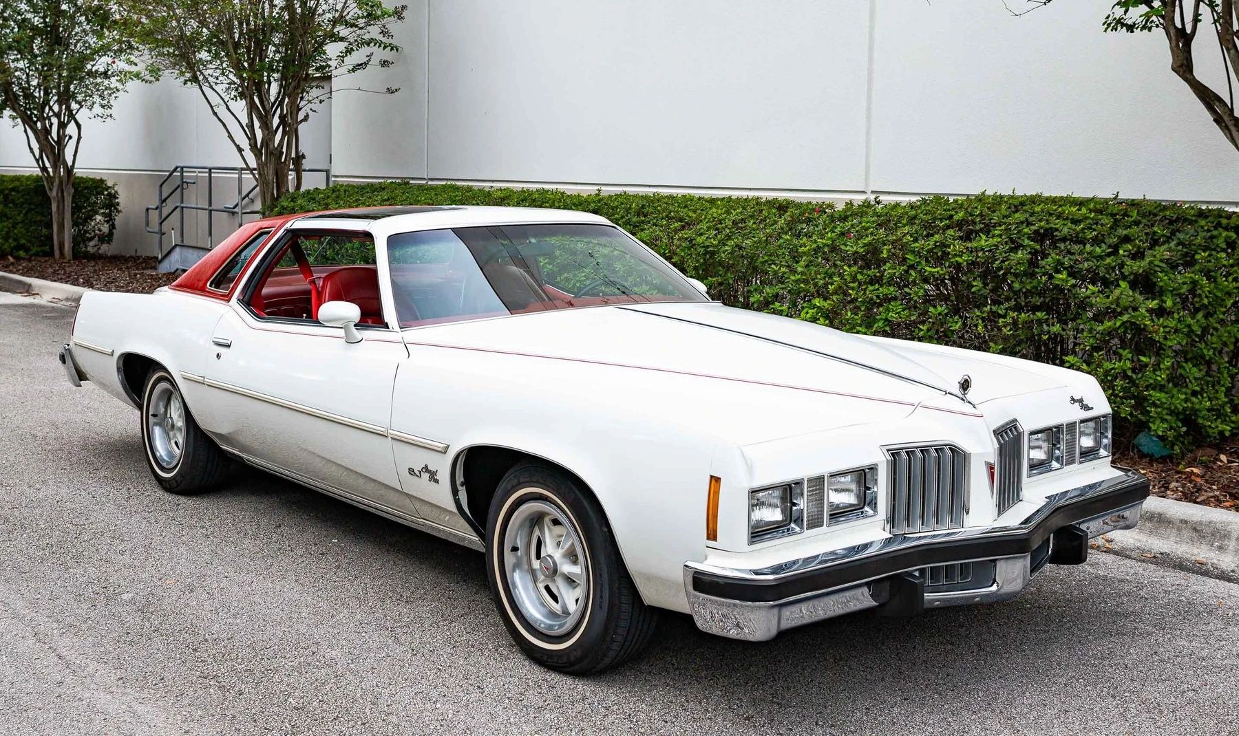Vintage M/T Road Test: 1979 Pontiac Grand Prix SJ – Rare 4-Speed Manual In A Pontiac PLC Placeholder 19 Right front 3q view of a white 1977 Pontiac Grand Prix with a red vinyl half-top