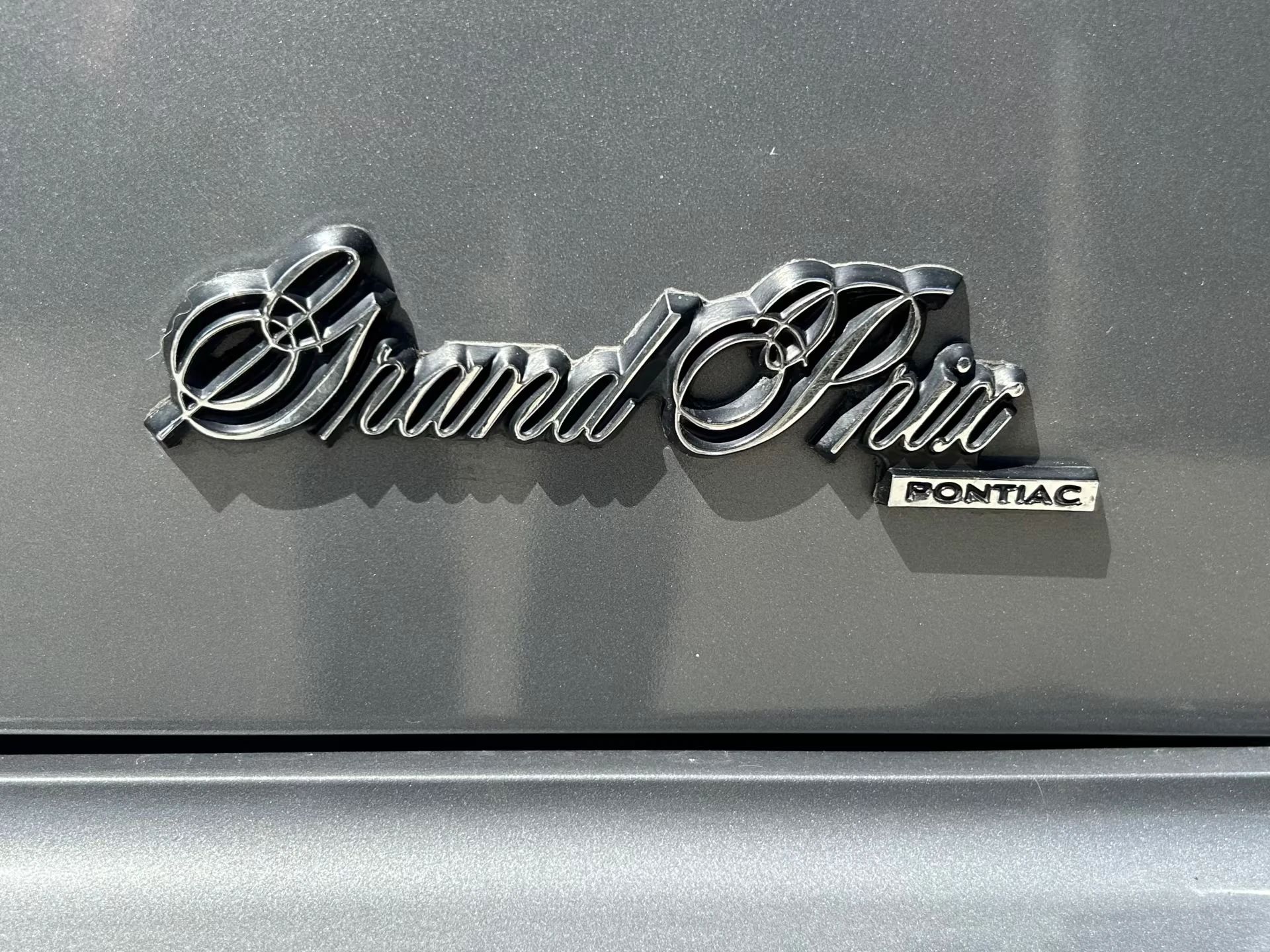 Vintage M/T Road Test: 1979 Pontiac Grand Prix SJ – Rare 4-Speed Manual In A Pontiac PLC Placeholder 17 Grand Prix script badge on a silver 1979 Pontiac Grand Prix