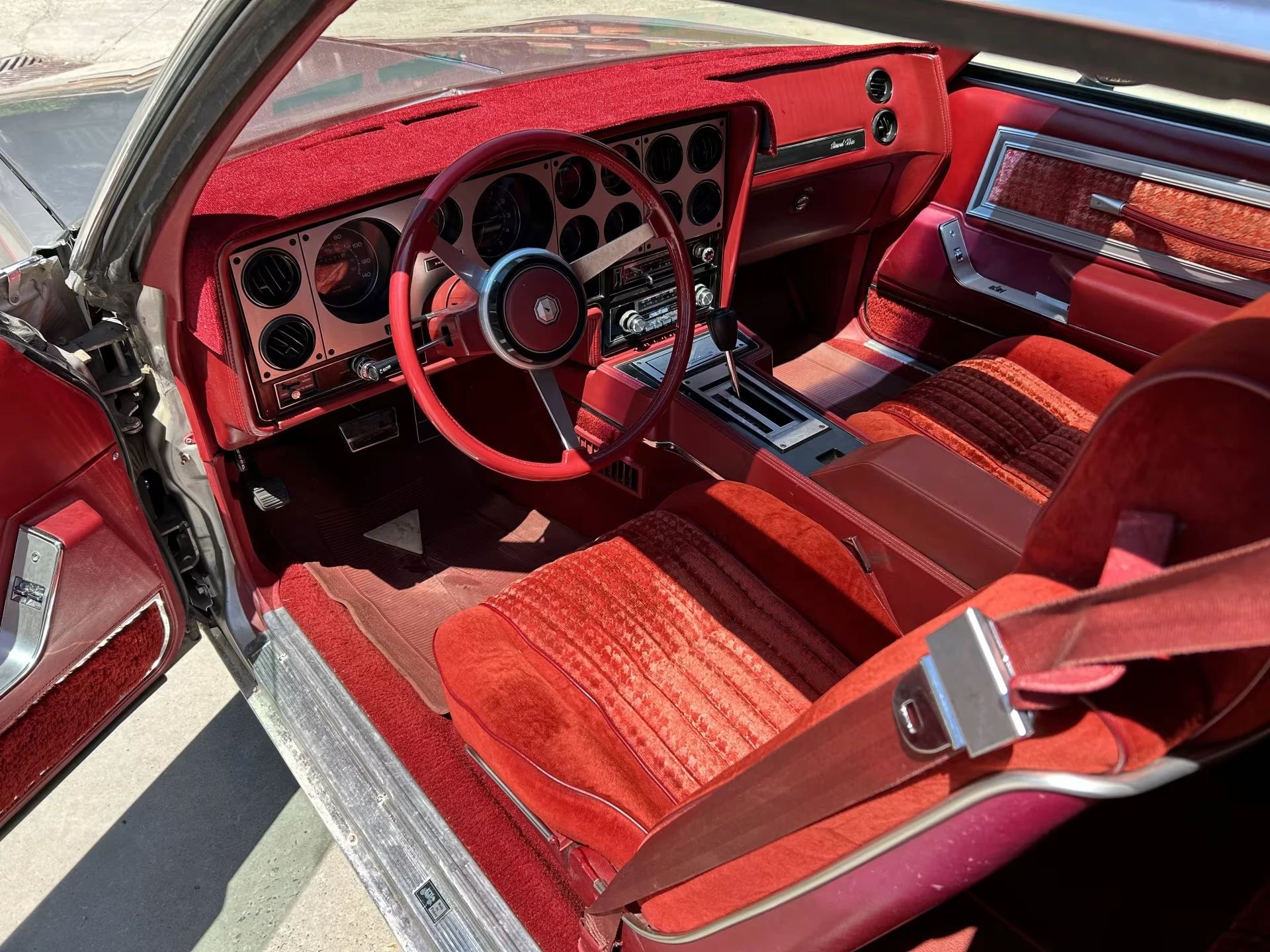 Vintage M/T Road Test: 1979 Pontiac Grand Prix SJ – Rare 4-Speed Manual In A Pontiac PLC Placeholder 8 Front seats and dashboard of a 1979 Pontiac Grand Prix SJ with bucket seats and red cloth upholstery