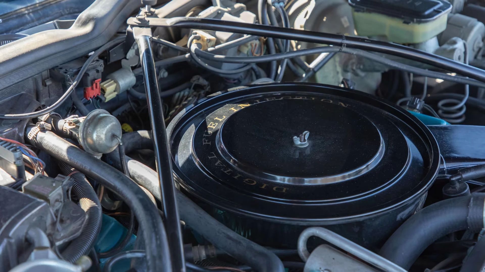 Close-up of the air cleaner of a V8-6-4 engine in a 1981 Cadillac Fleetwood Brougham