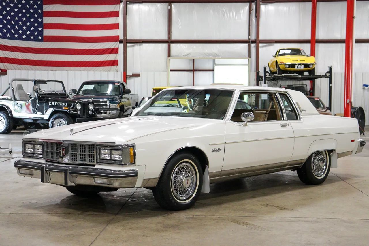 1985 Cadillac De Ville 4.3 V-6 Diesel: The Most Underpowered Cadillac Since Before WW2 7 Left front 3q view of a white 1981 Oldsmobile Ninety-Eight Regency coupe with wire wheels