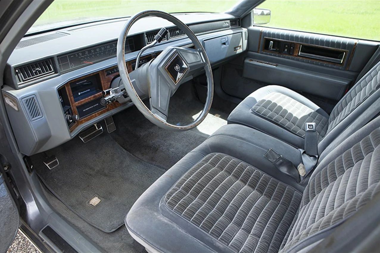 1985 Cadillac De Ville 4.3 V-6 Diesel: The Most Underpowered Cadillac Since Before WW2 18 Front seat and dashboard of a 1985 Cadillac Sedan de Ville with gray cloth upholstery