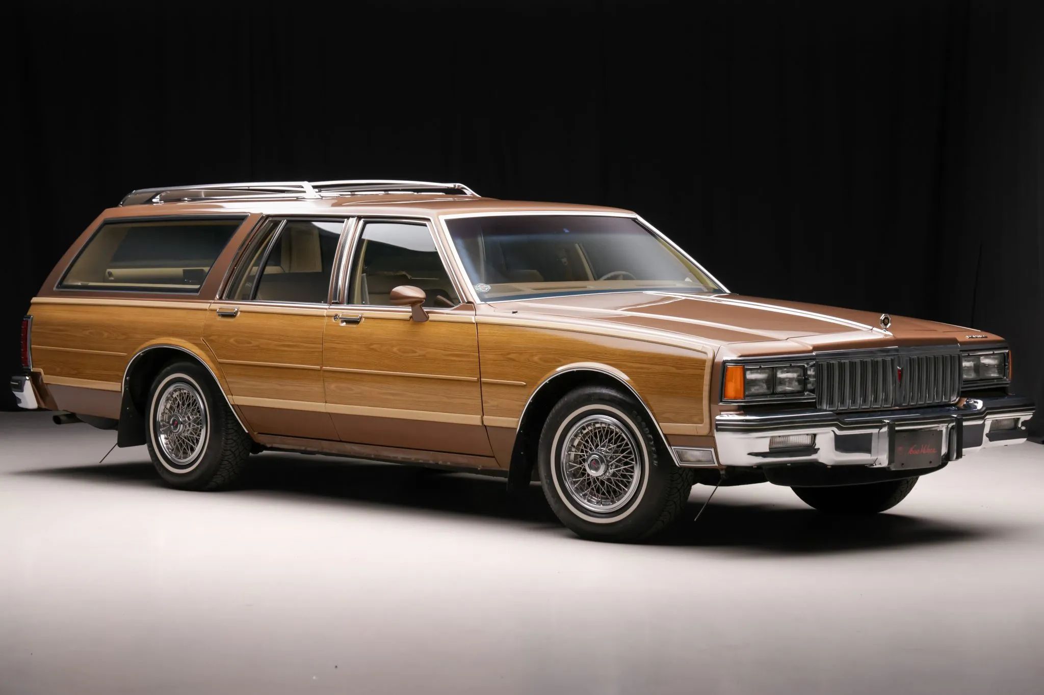 1990 Buick Estate Wagon: Luxurious Family Hauler The Old-Fashioned Way 5 Studio right front 3q view of a brown 1987 Pontiac Safari station wagon