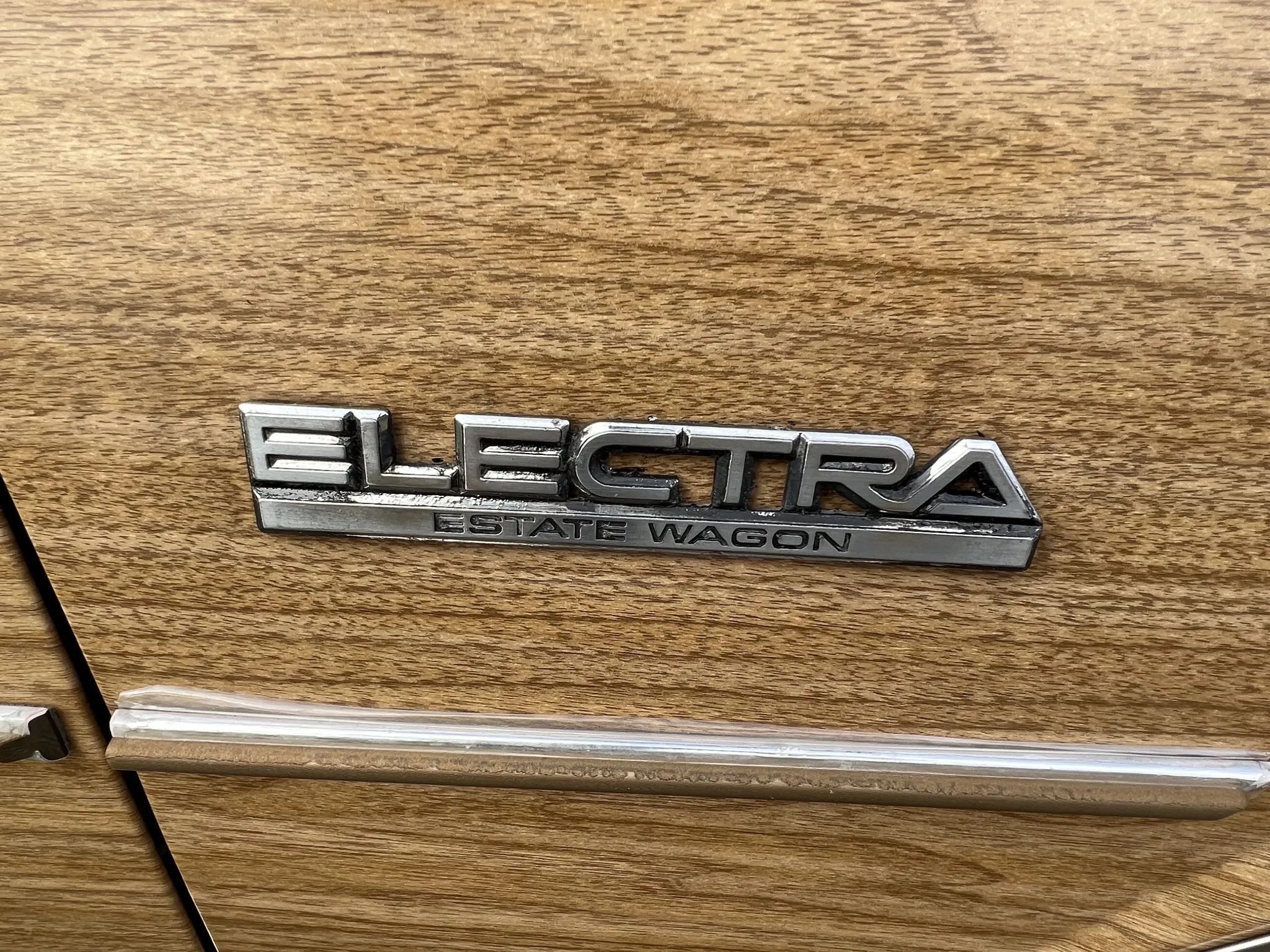 1990 Buick Estate Wagon: Luxurious Family Hauler The Old-Fashioned Way 6 Electra Estate Wagon badge on wood paneling of a 1988 Buick Electra station wagon