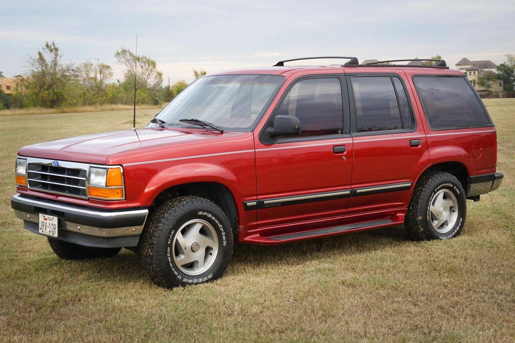 1990 Buick Estate Wagon: Luxurious Family Hauler The Old-Fashioned Way 29 Left front 3q view of a red 1991 Ford Explorer five-door parked on grass