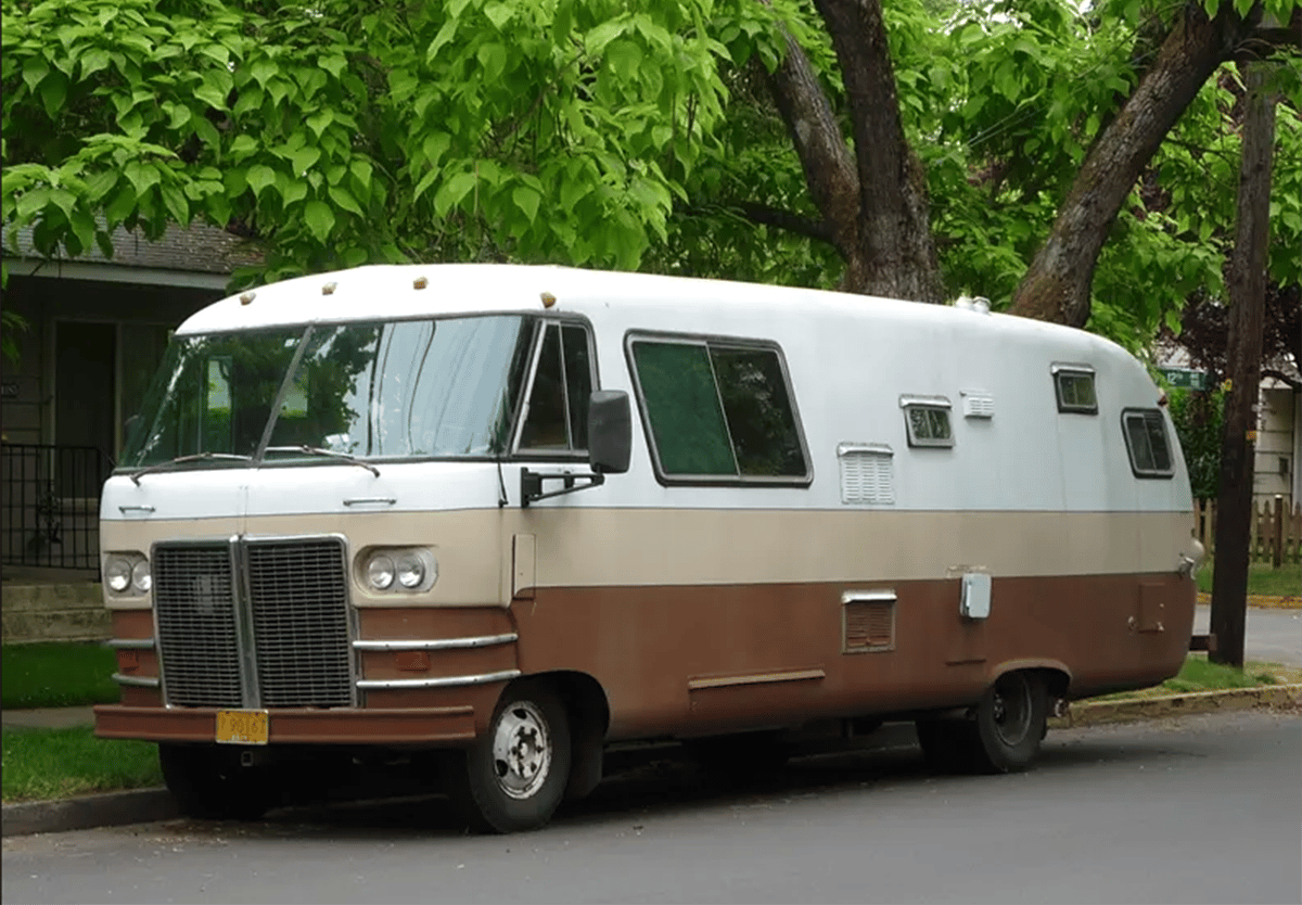Travco Motorhome: The Granddaddy Of The Motorhome Name And Genre 1 Travco Motorhome in three-tone white, beige, and brown colors, parked by the curbside