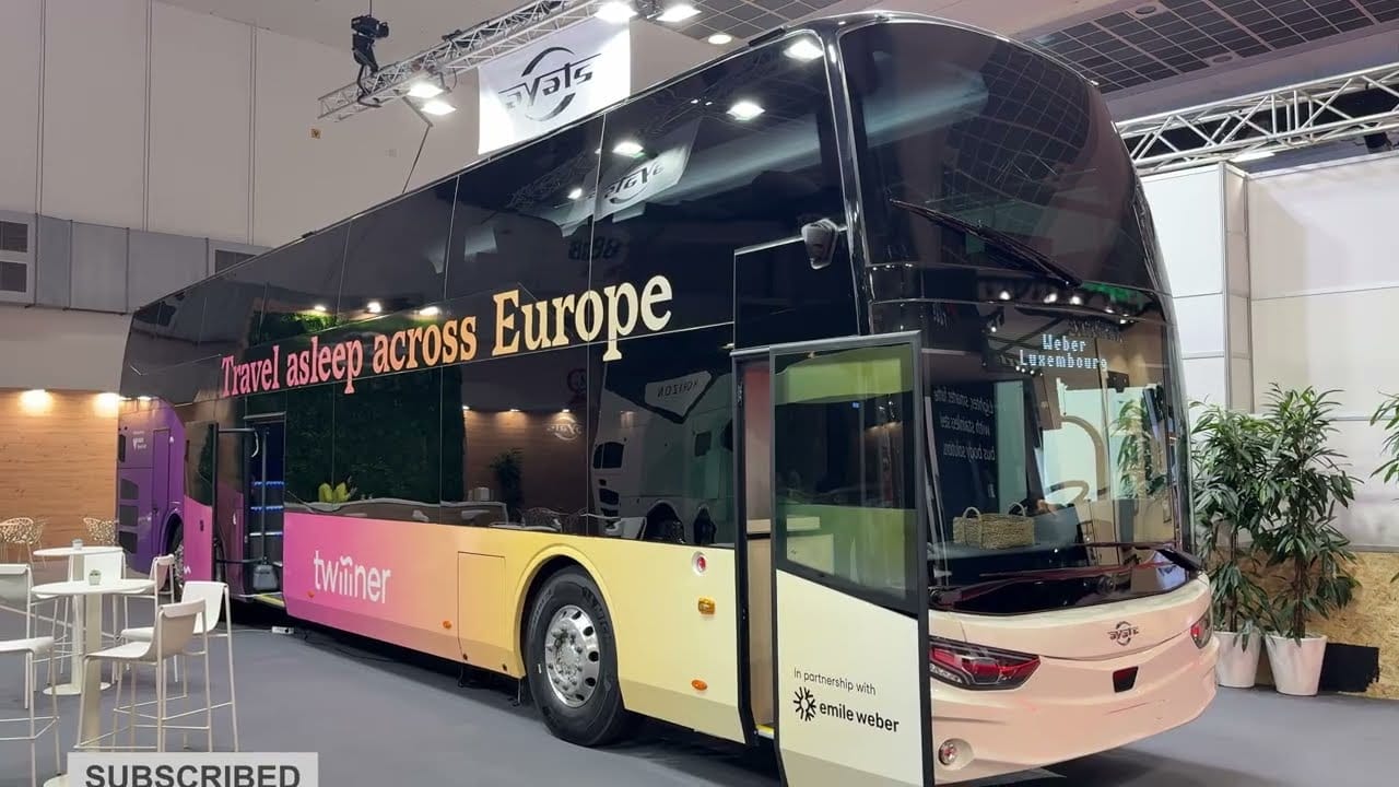 Image of a 2025 Ayats Twiliner Overnight Coach Bus in an interior display.