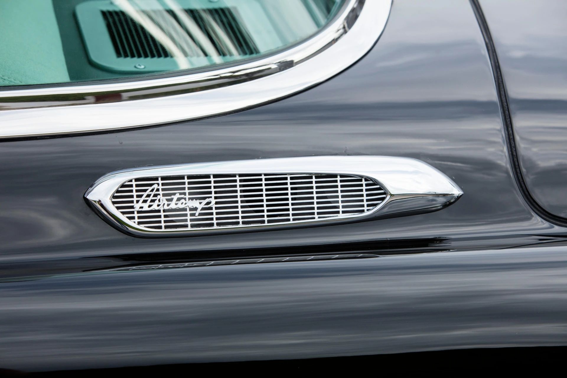 Airtemp air conditioning inlet on the left rear quarter panel of a black 1953 Chrysler Custom Imperial