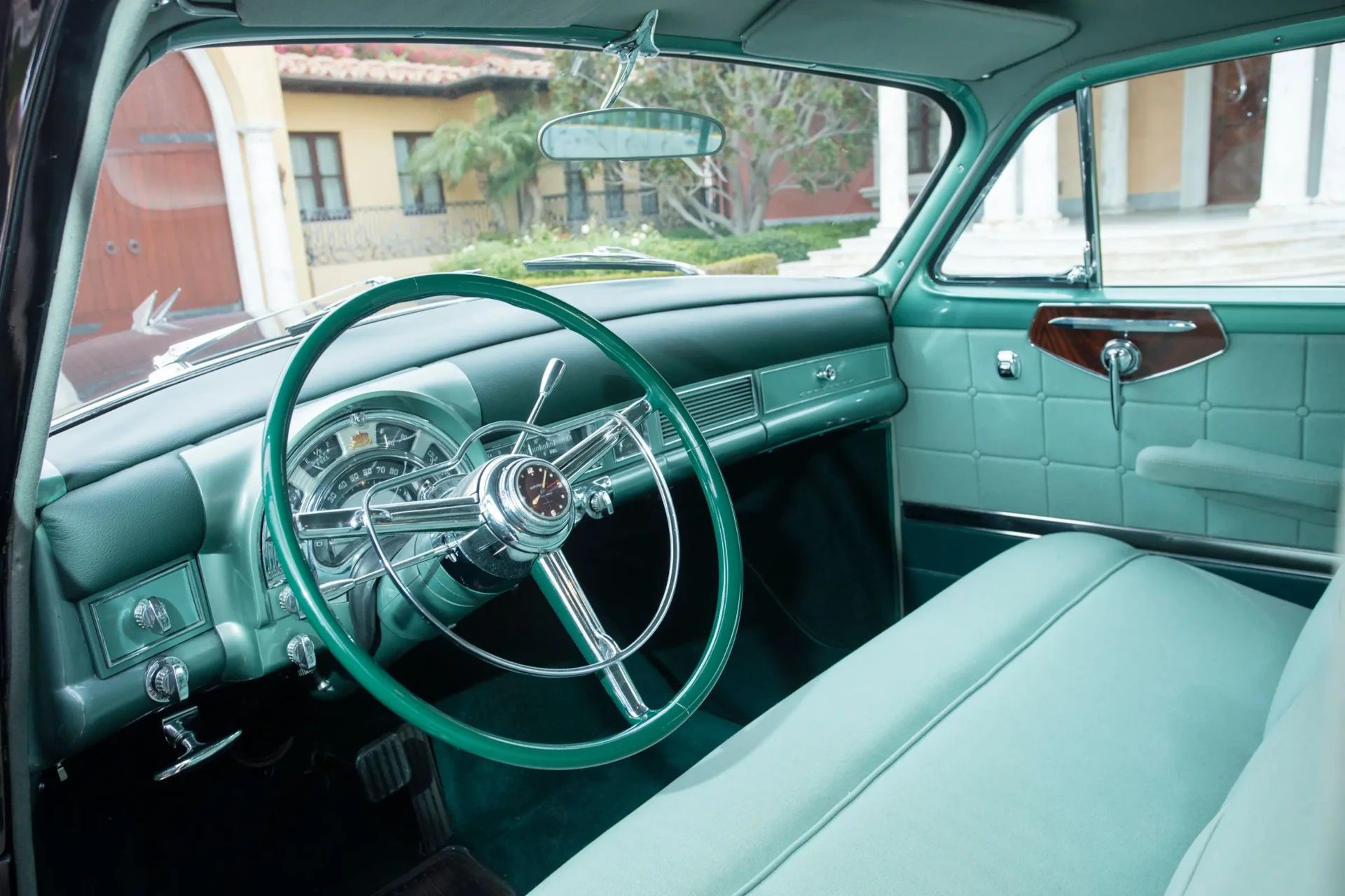Dashboard and front seat of a 1953 Chrysler C-58 Custom Imperial with green interior