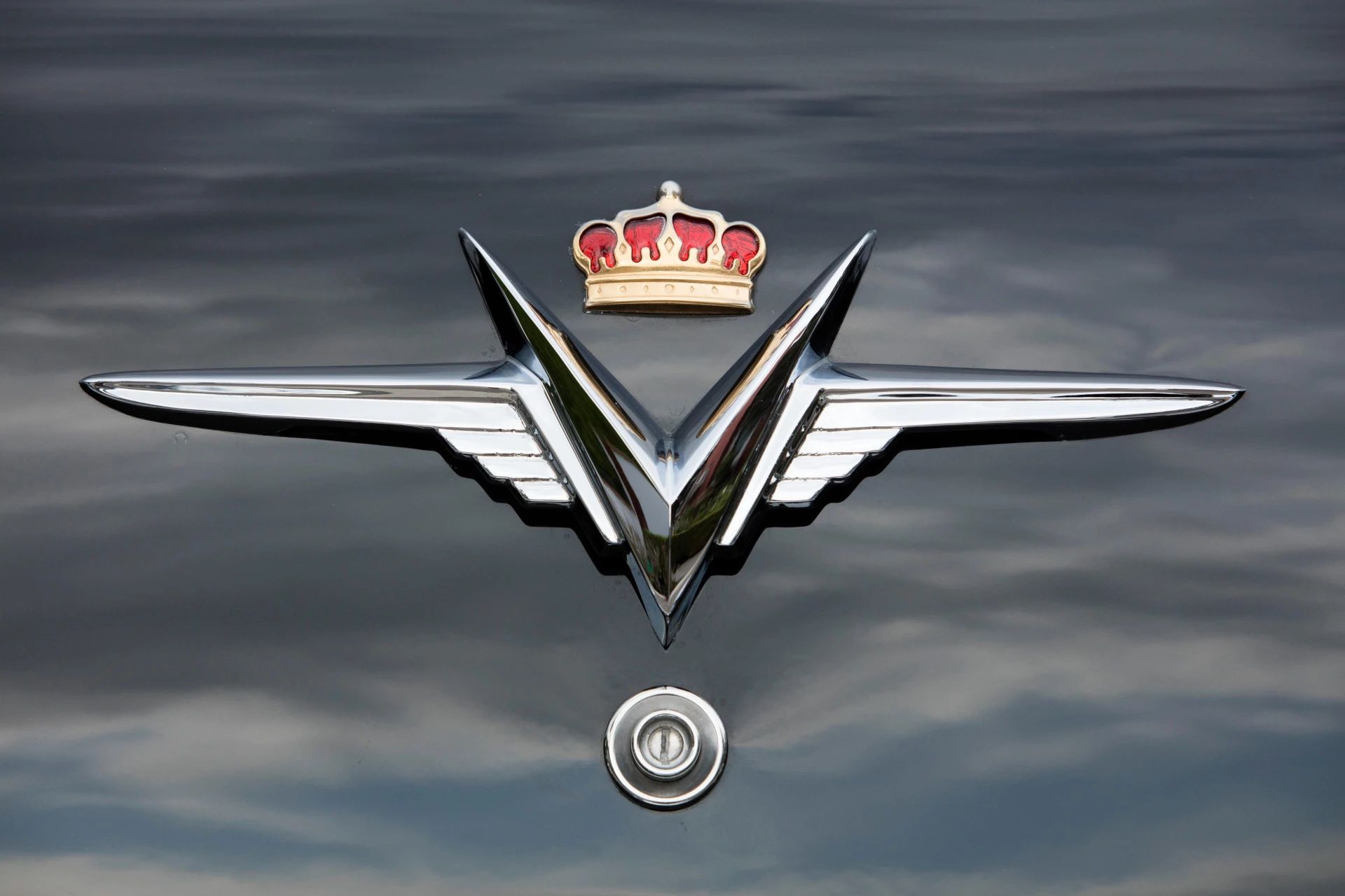 Crown emblem on the rear deck of a black 1953 Chrysler Custom Imperial